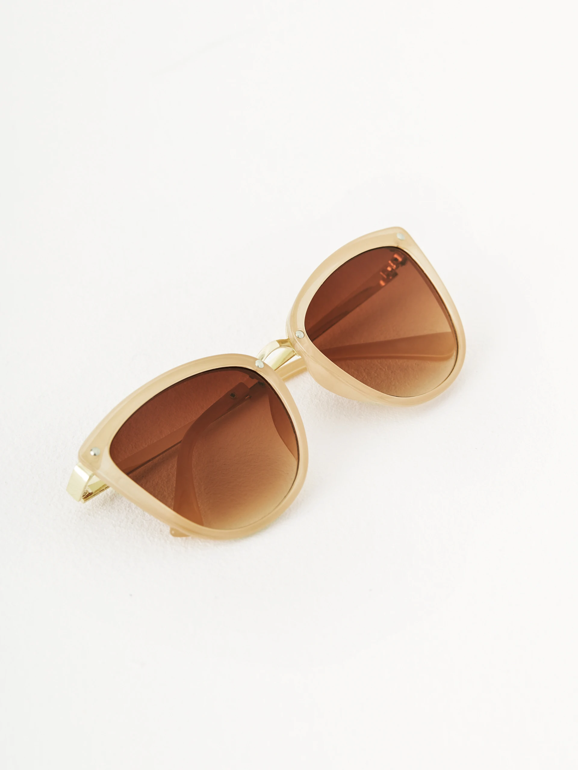Beige sunglasses in cat-eye shape