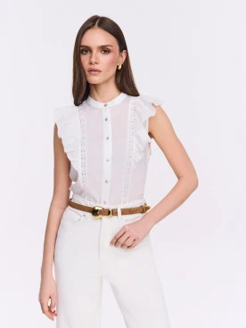 White button-down blouse with openwork embellishments and a stand-up collar