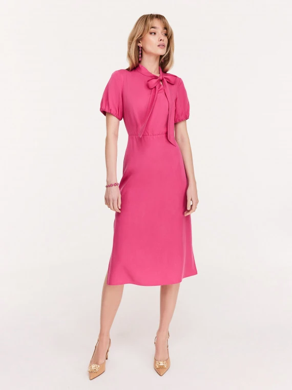 Pink knee-length dress with a bow at the neck