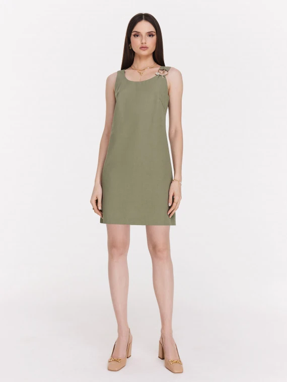 Green minimalist dress with decorative clutch