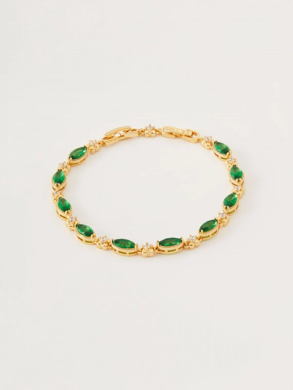 Bracelet in gold color with green crystals