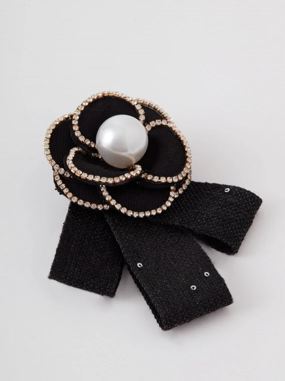 Black bow-shaped brooch with flower