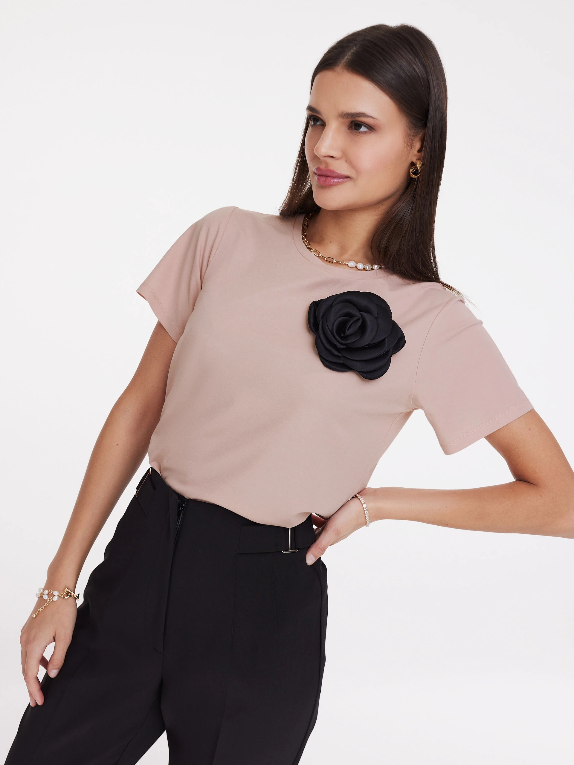 Undersized pink blouse with rose embellishment
