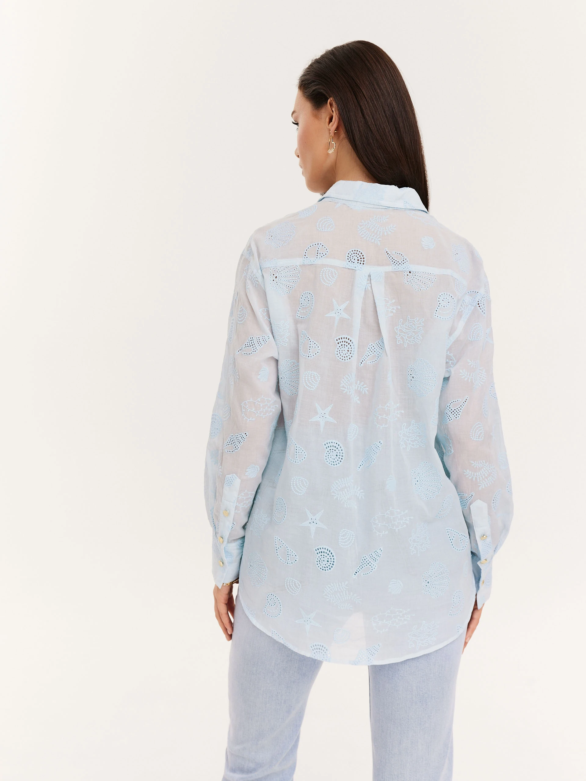 Blue shirt with decorative buttons and openwork inserts