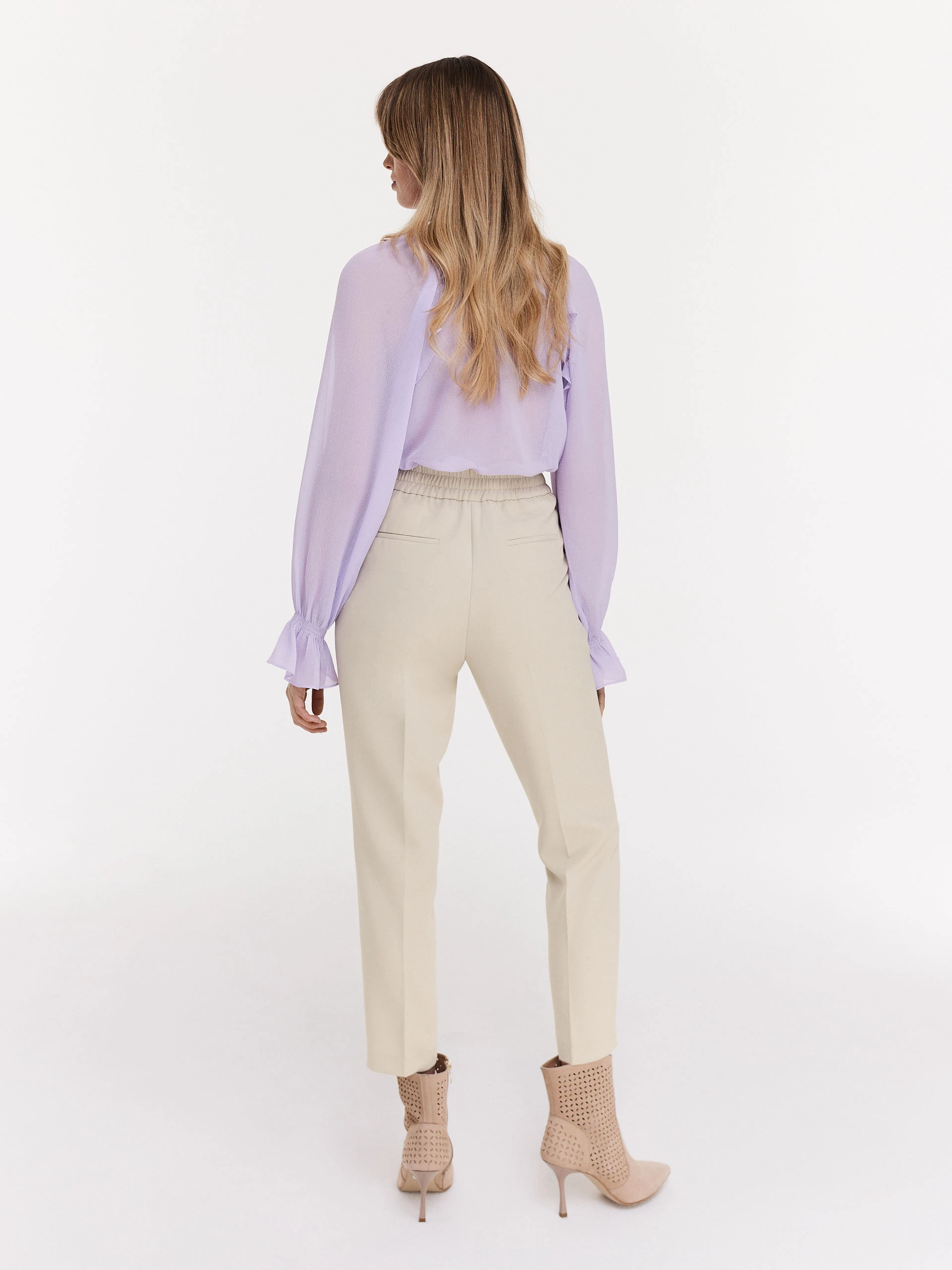 Beige cigarette pants with decorative buttons