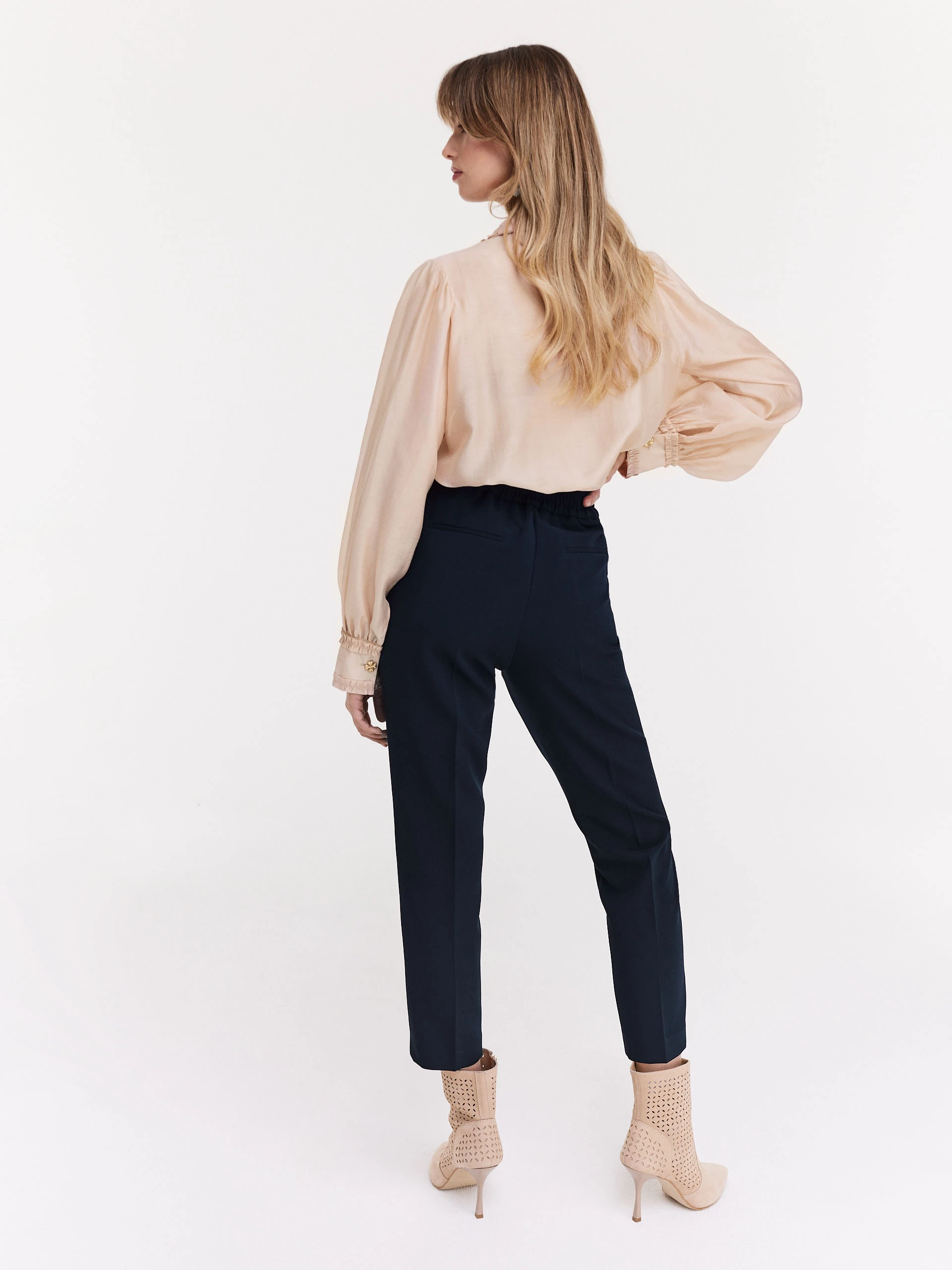Navy blue cigarette pants with decorative buttons