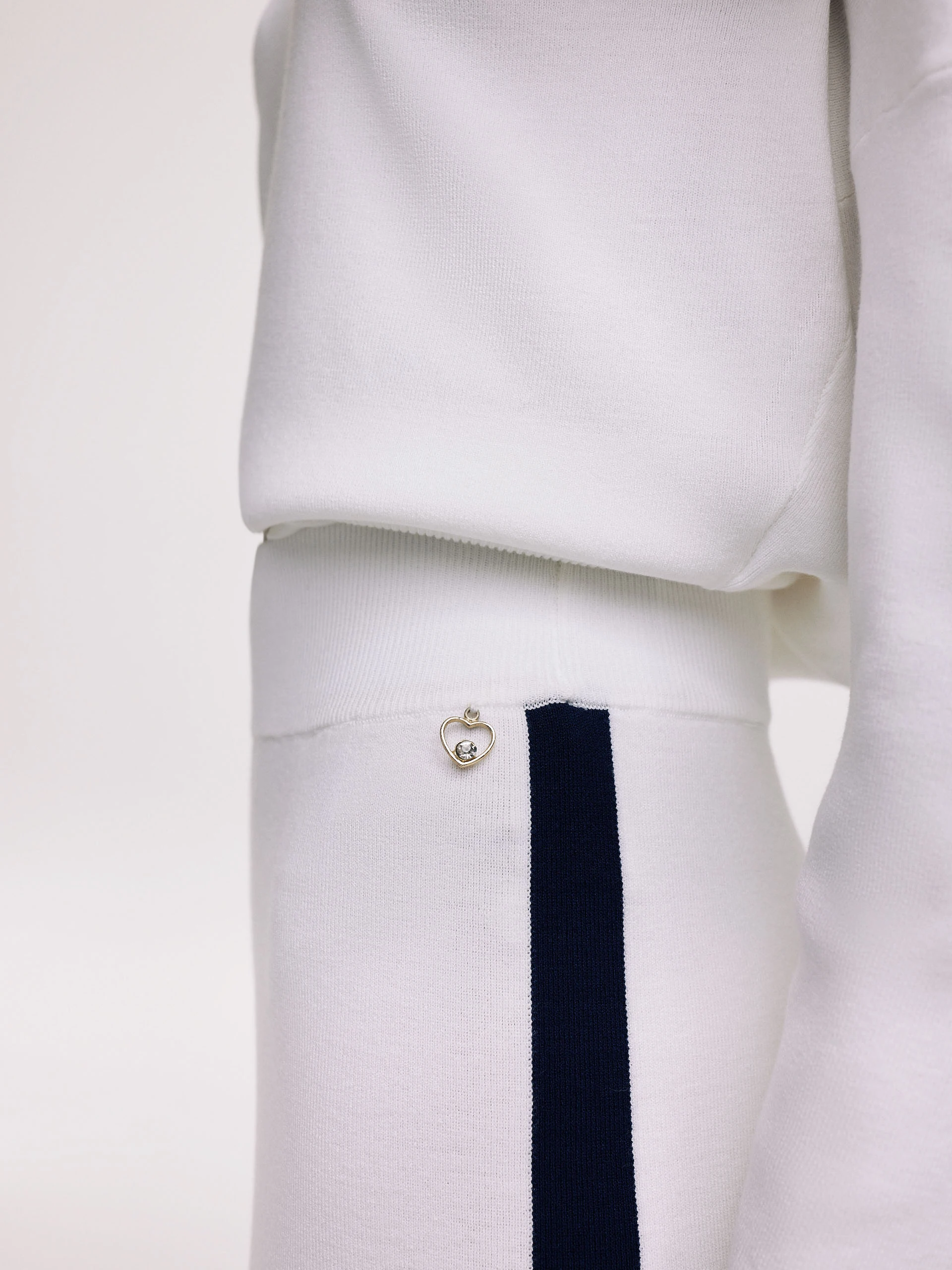 White pants with navy blue piping