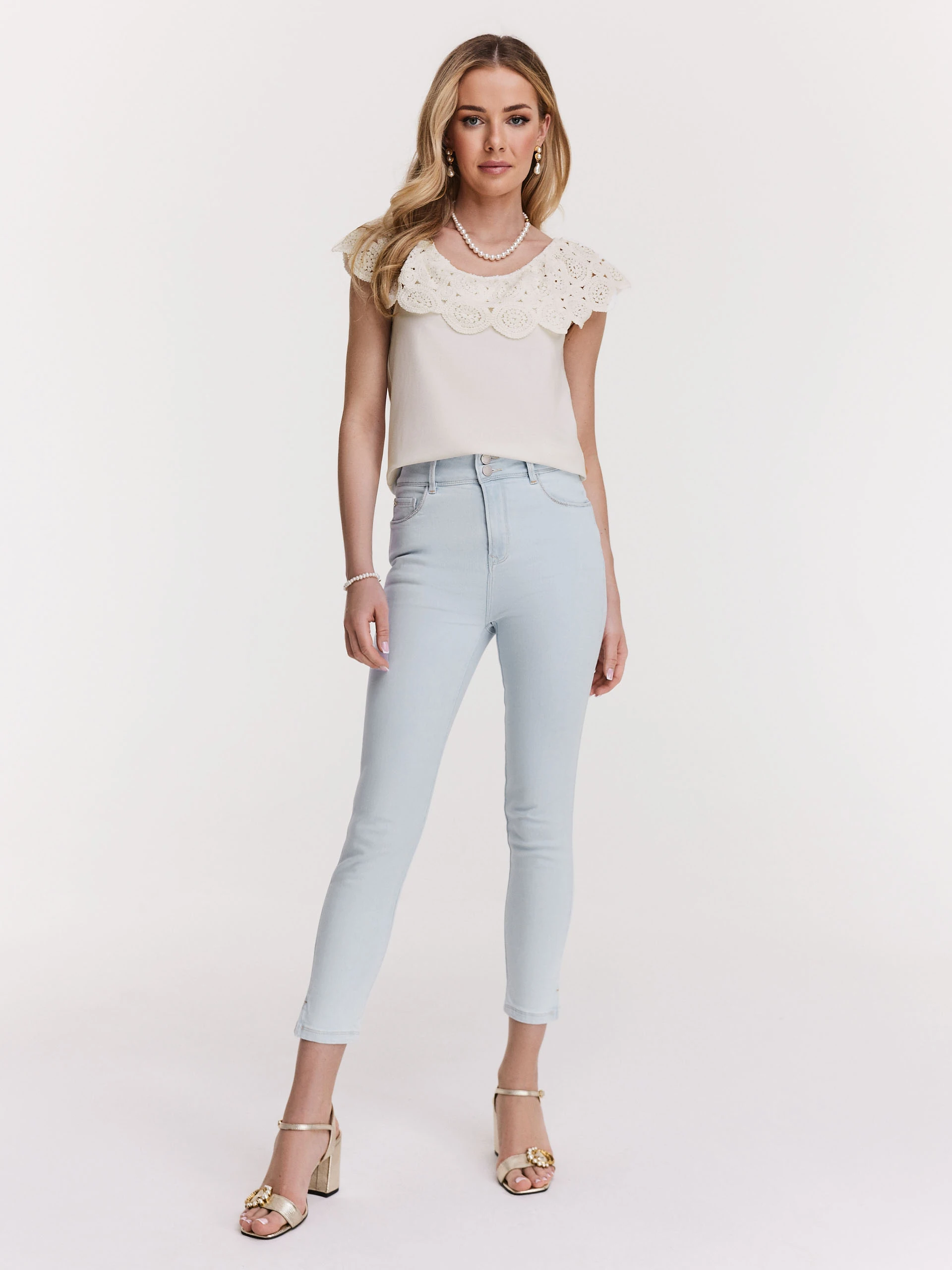 White blouse with lace embellishment at the neckline