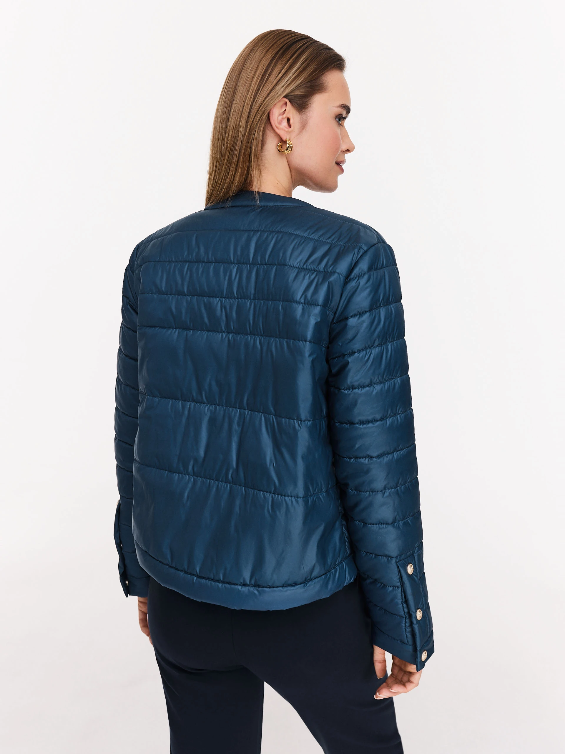 Navy blue quilted jacket with decorative buttons