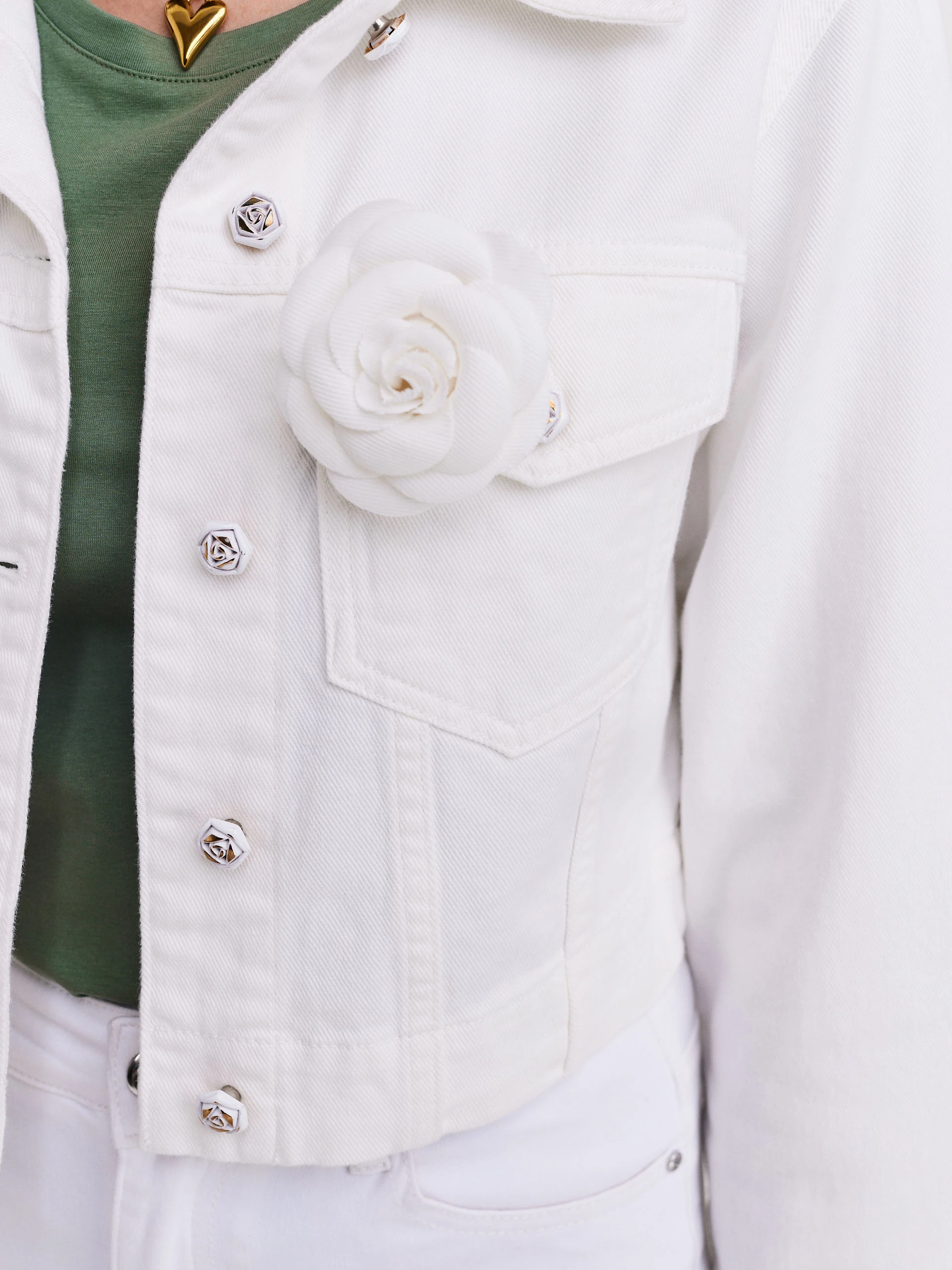 Short white jacket with decorative buttons and rose