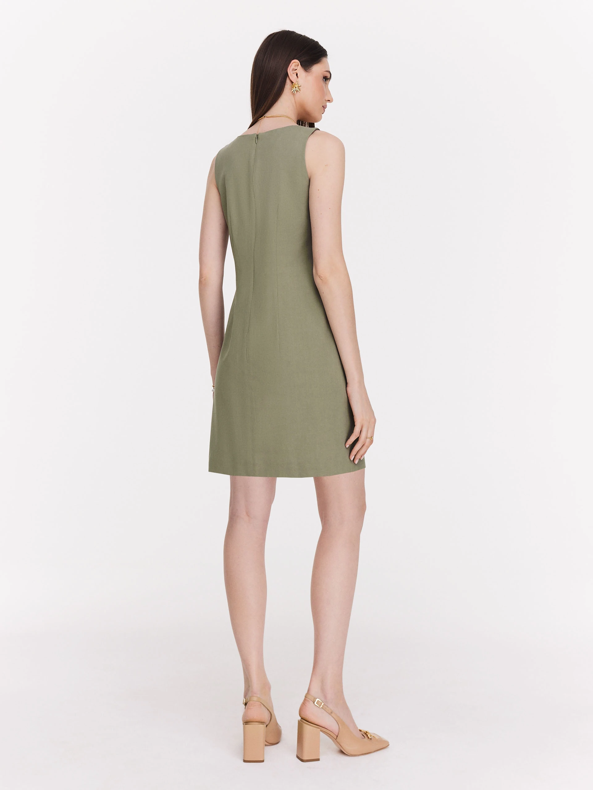 Green minimalist dress with decorative clutch
