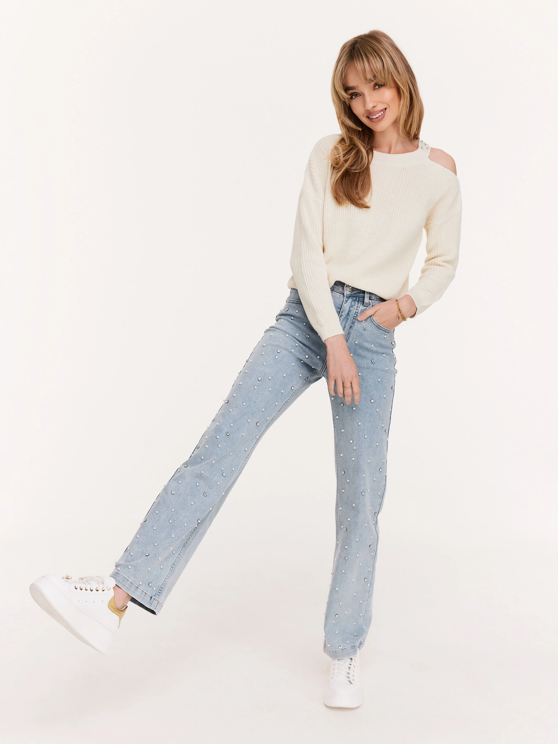 Cream sweater with striking cutouts
