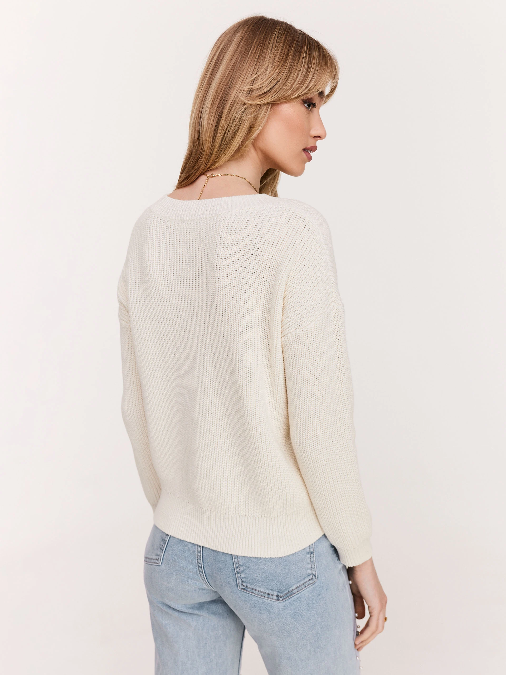 Cream sweater with striking cutouts