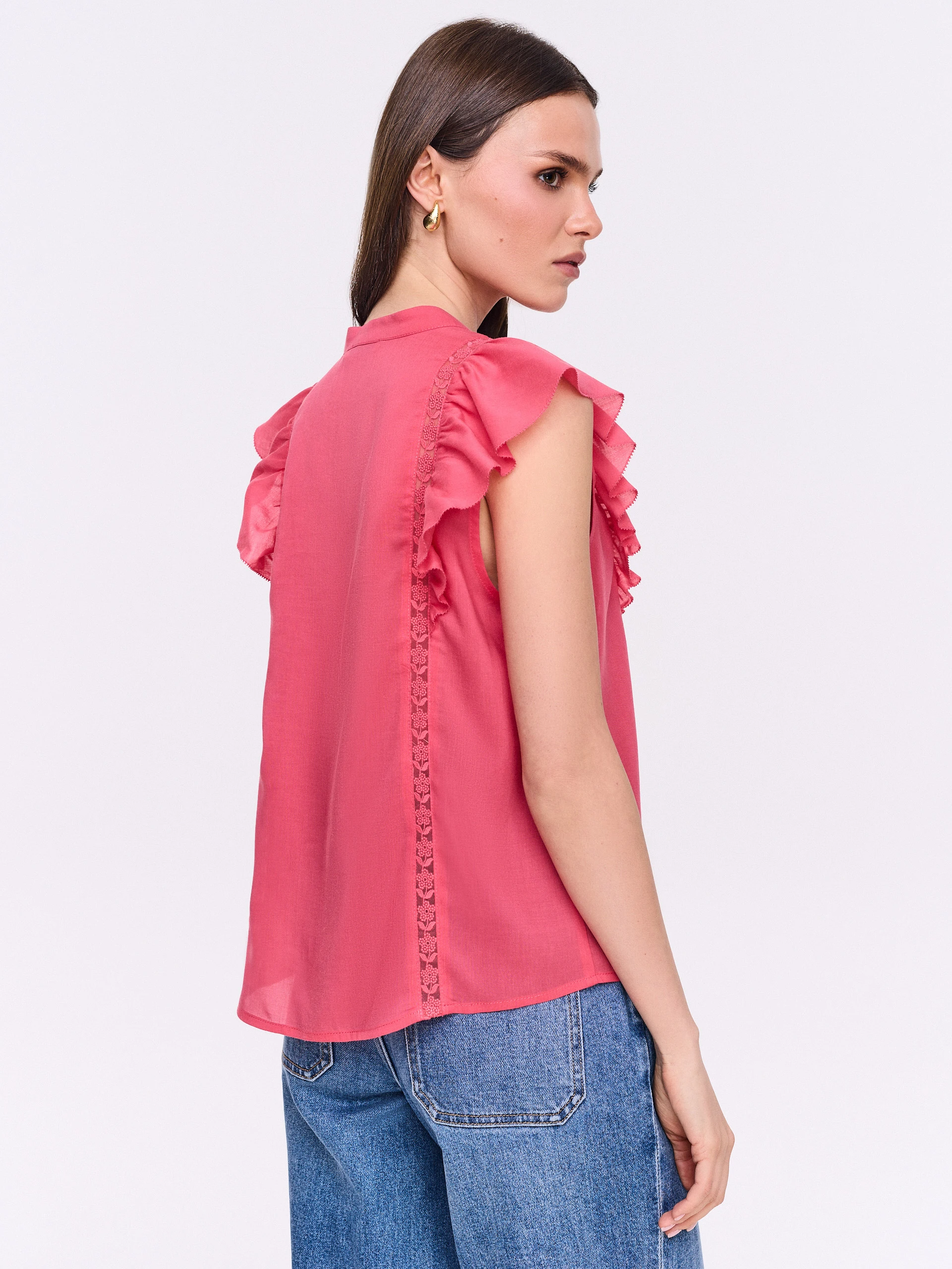 Coral button-down blouse with openwork embellishments and a stand-up collar
