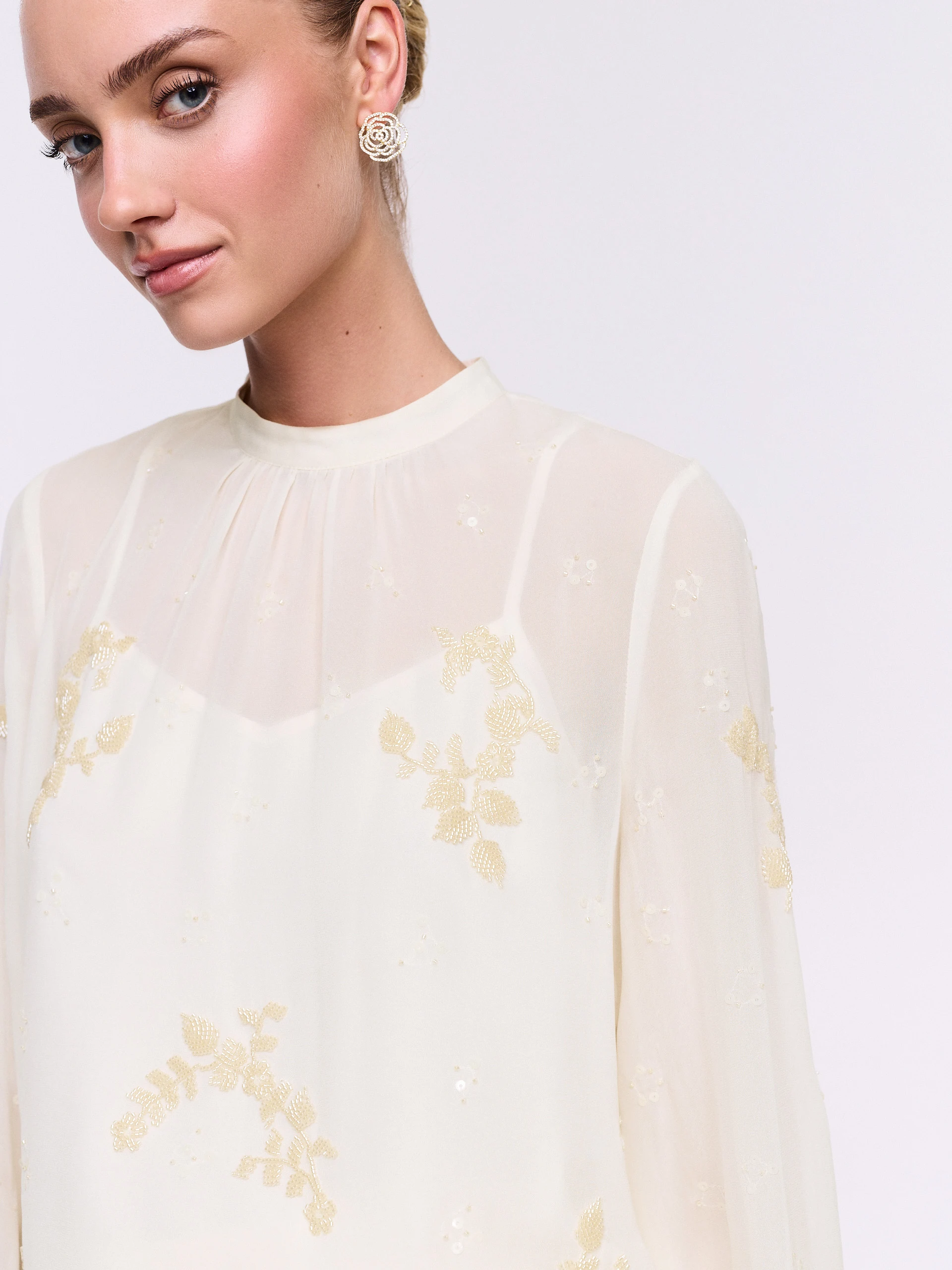 An elegant blouse with decorative appliqués
