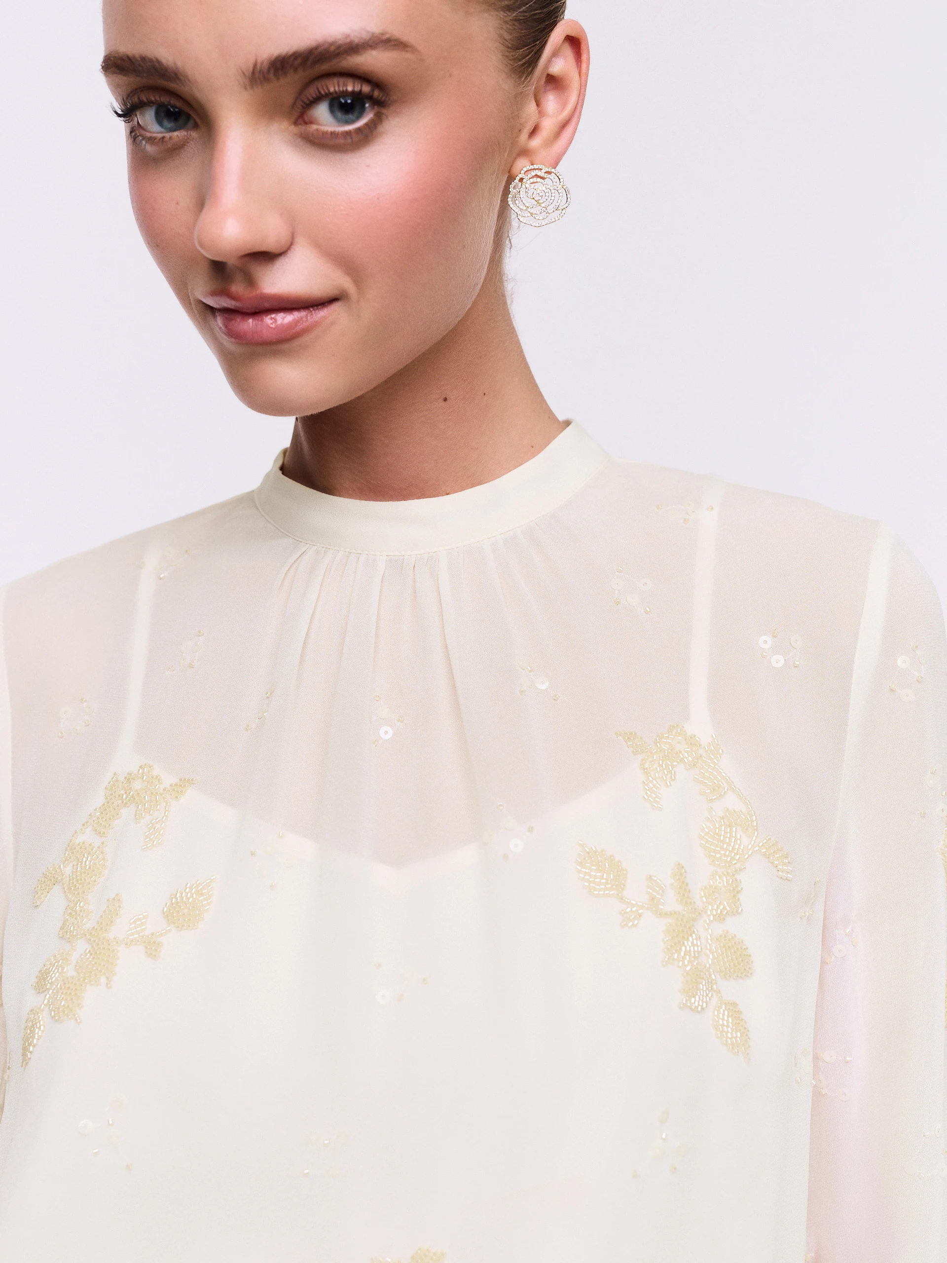 An elegant blouse with decorative appliqués