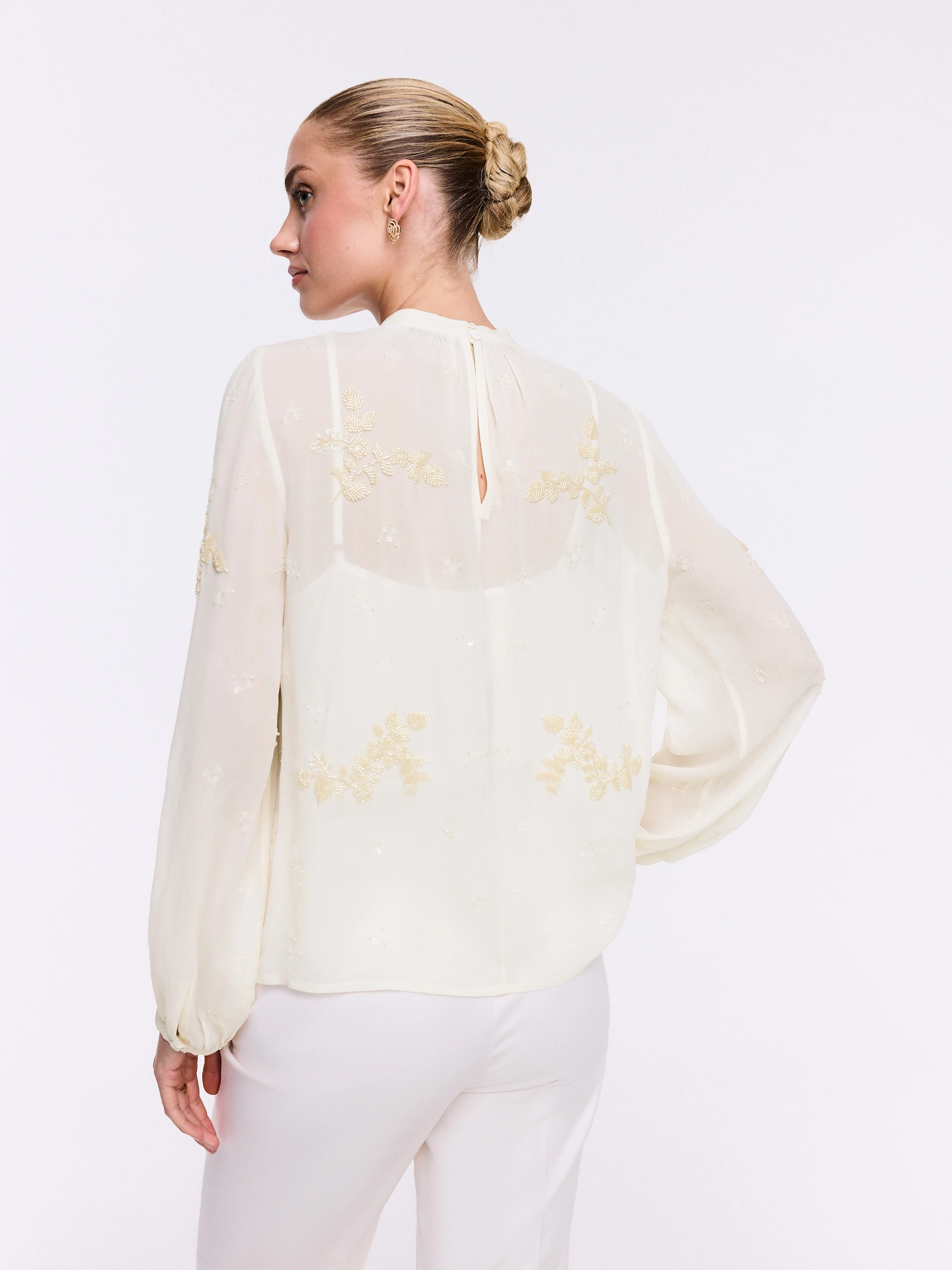 An elegant blouse with decorative appliqués