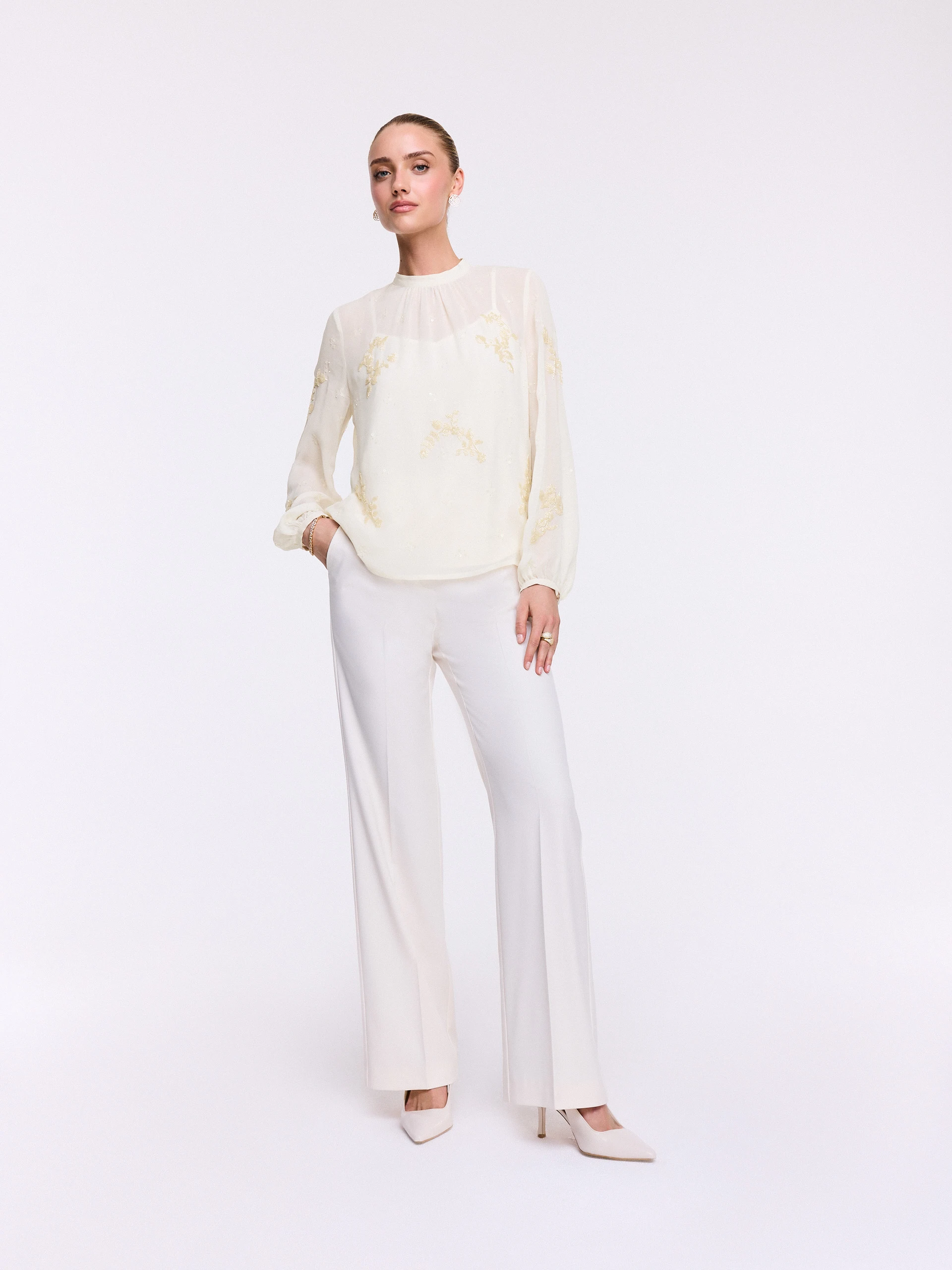 An elegant blouse with decorative appliqués