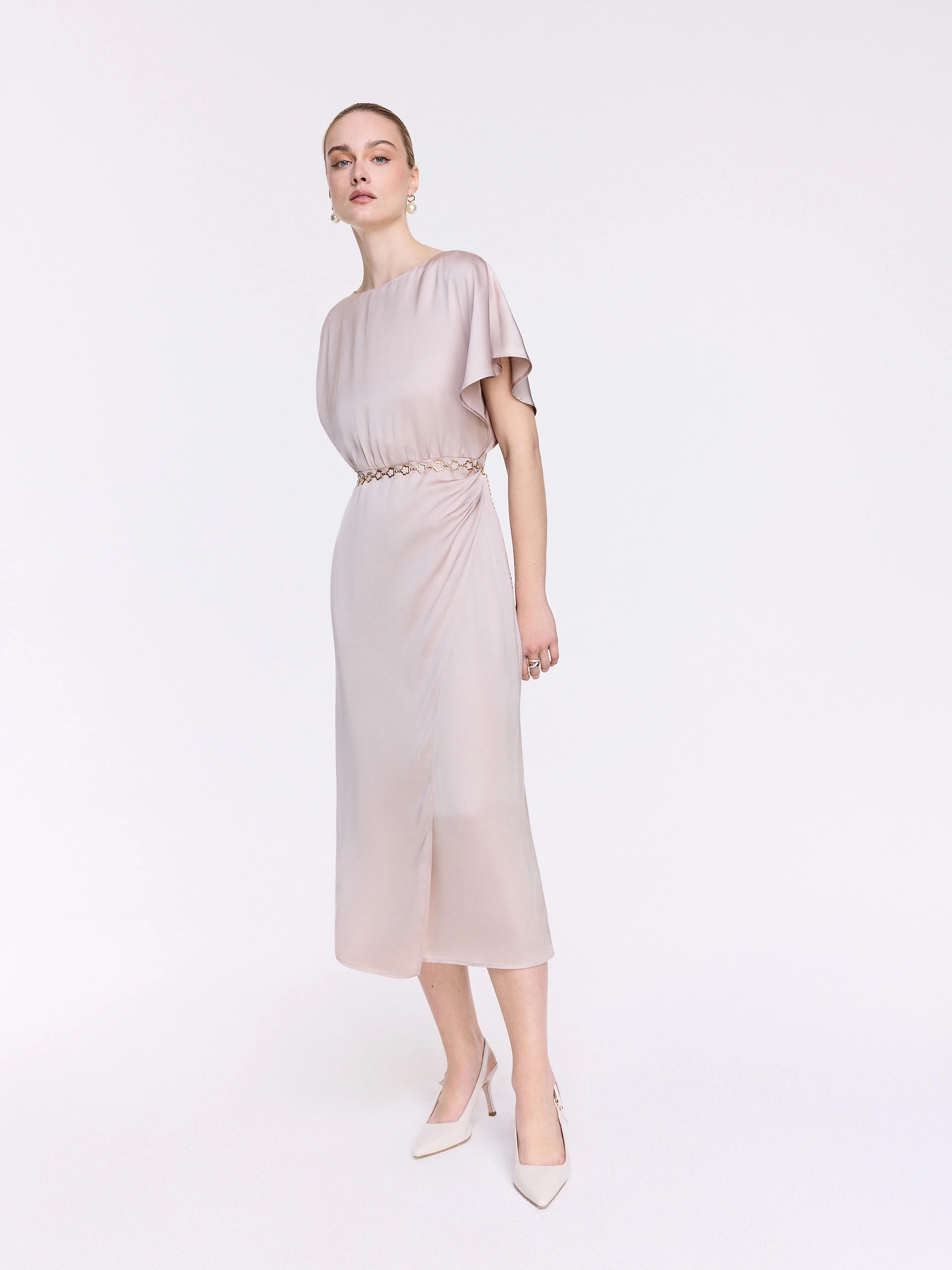 A glamorous dress with an asymmetrical sleeve