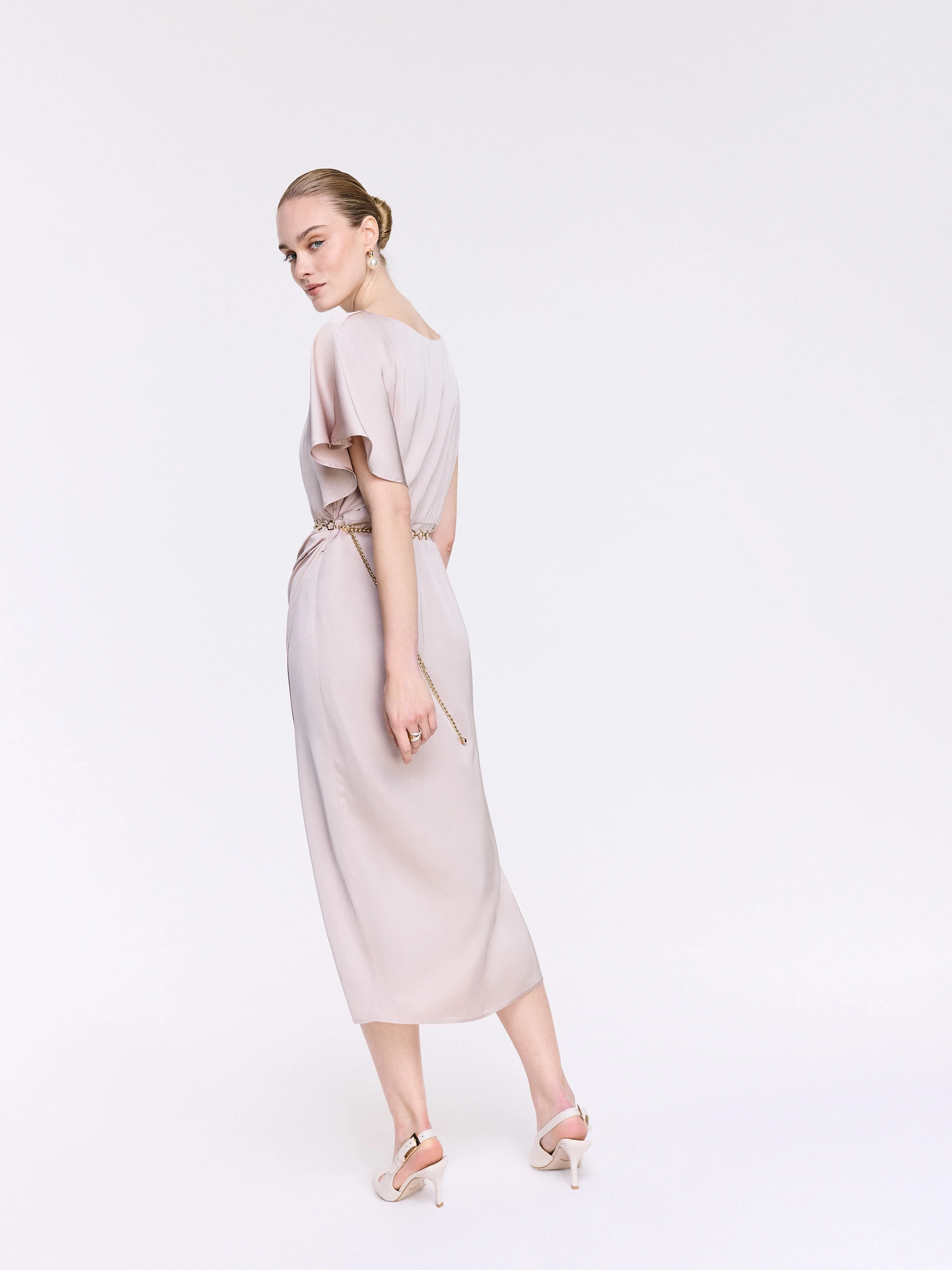 A glamorous dress with an asymmetrical sleeve