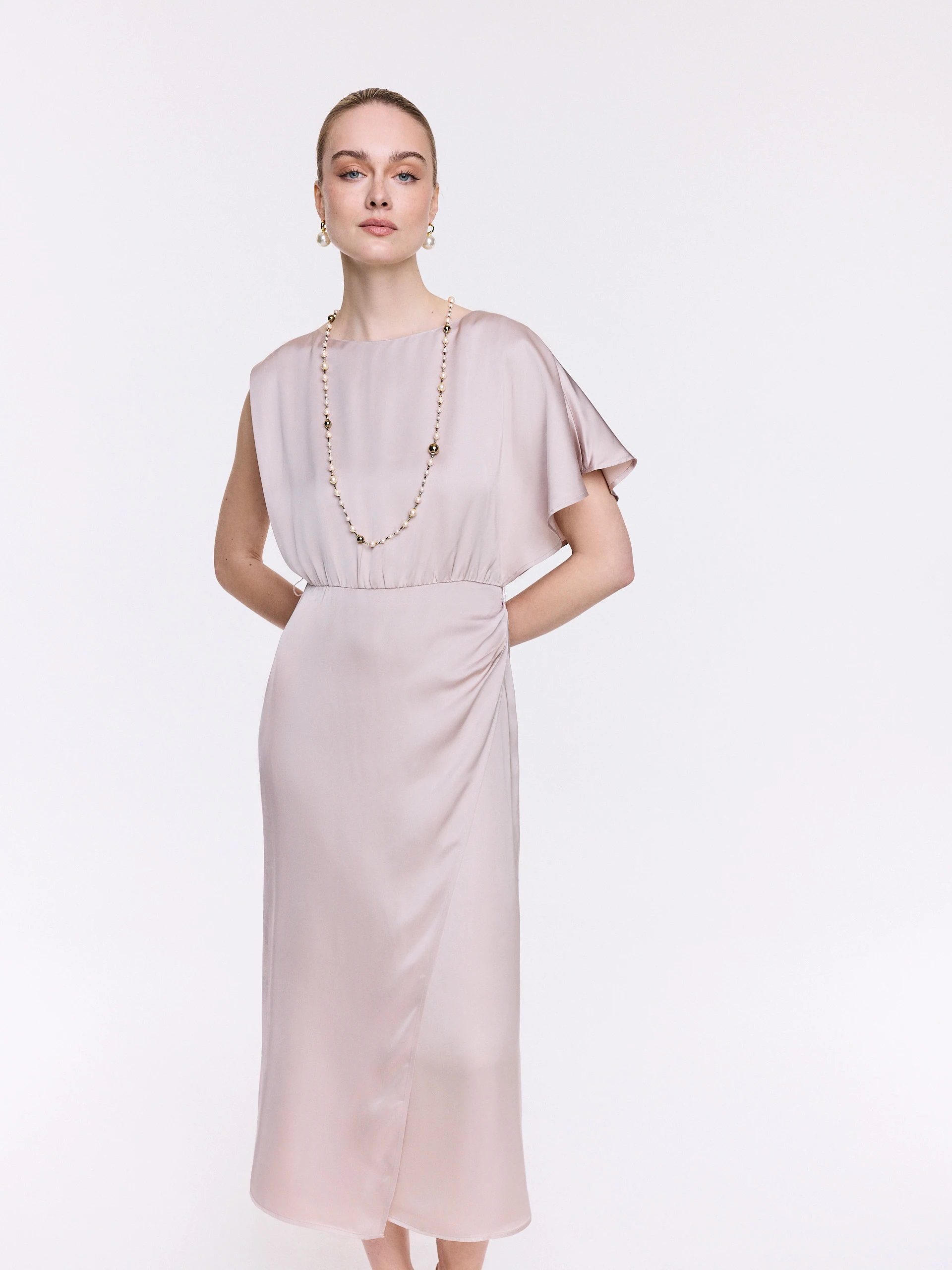A glamorous dress with an asymmetrical sleeve