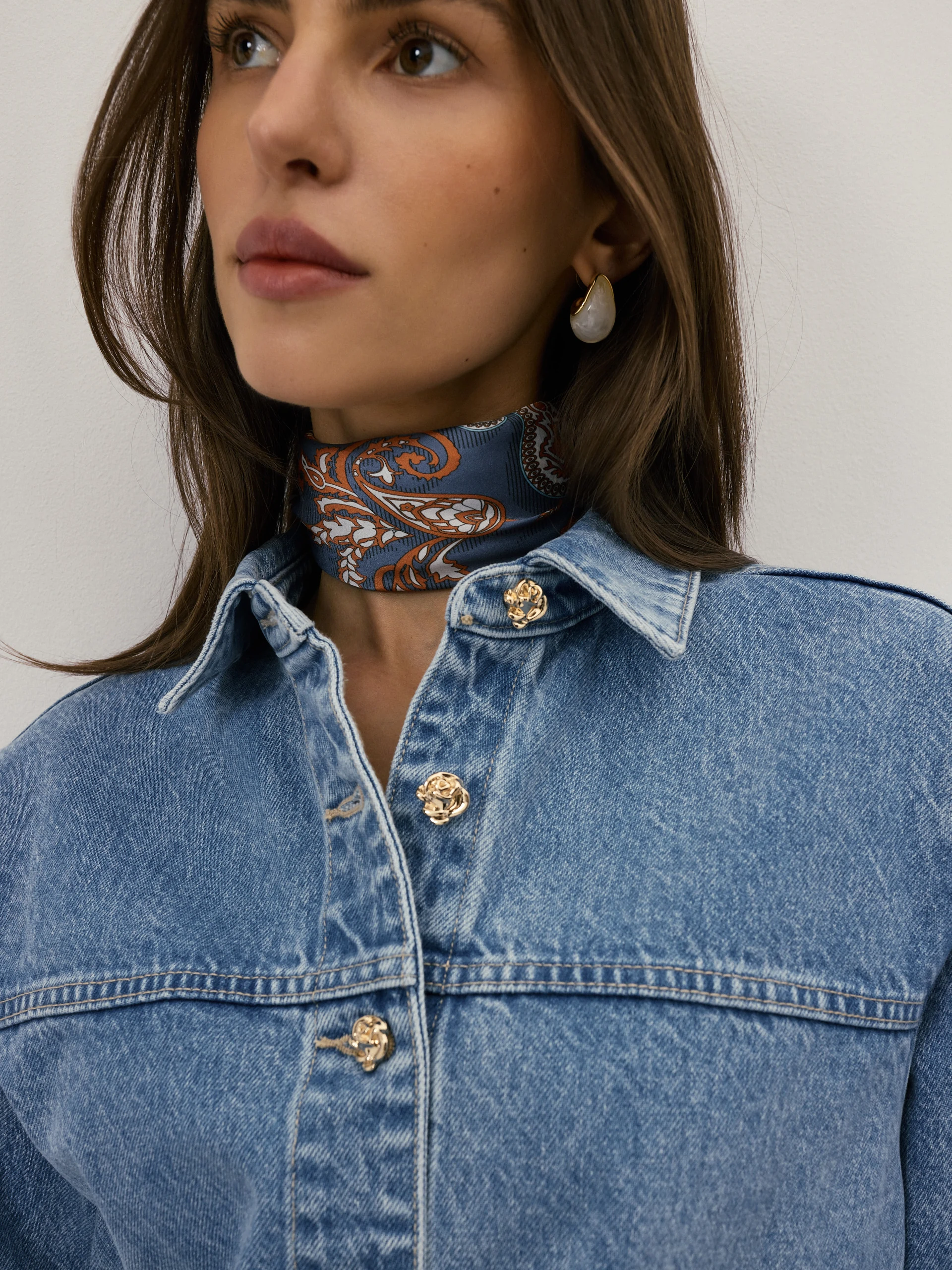 Denim jacket with decorative buttons