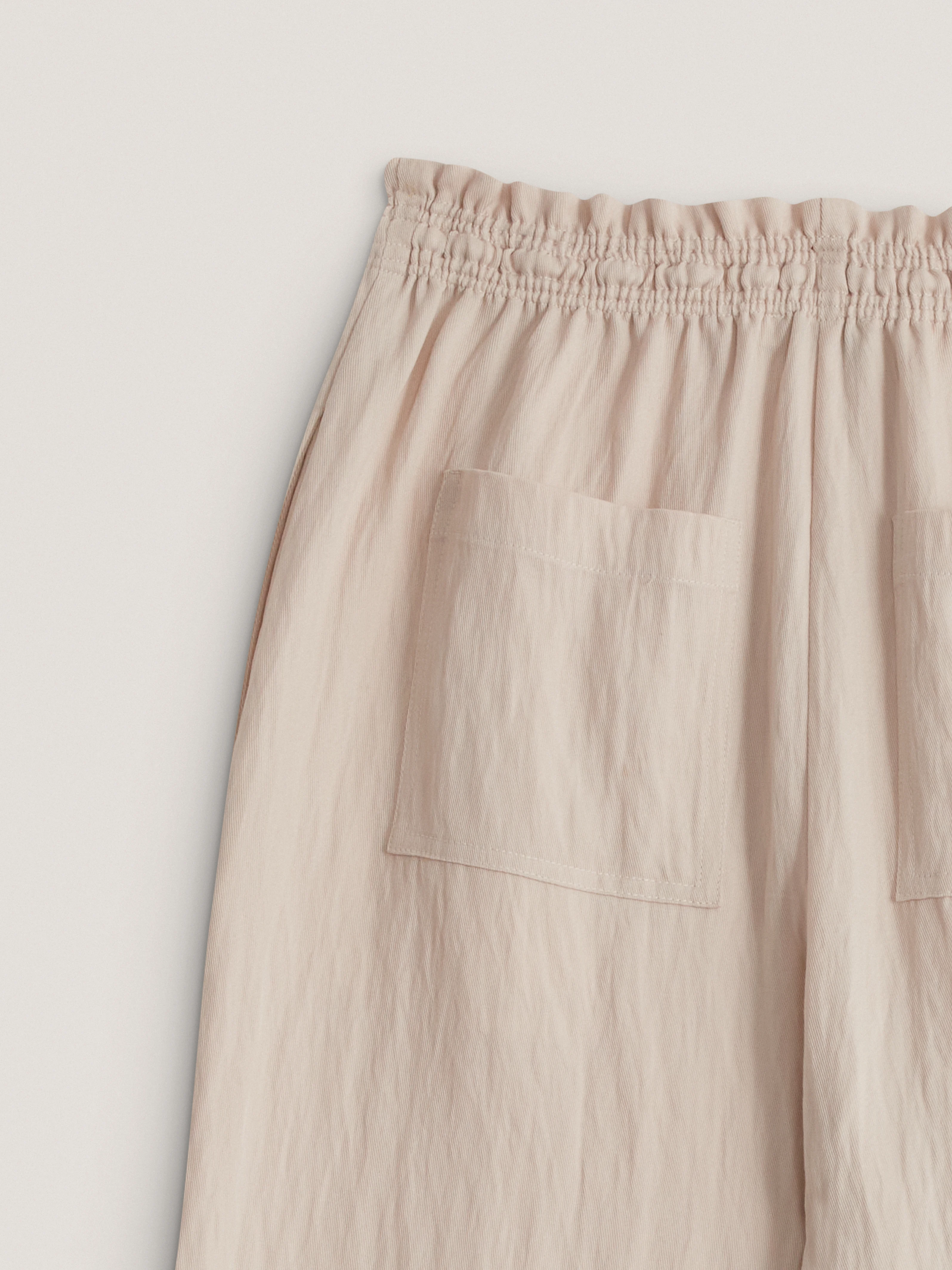 Loose-fitting beige trousers