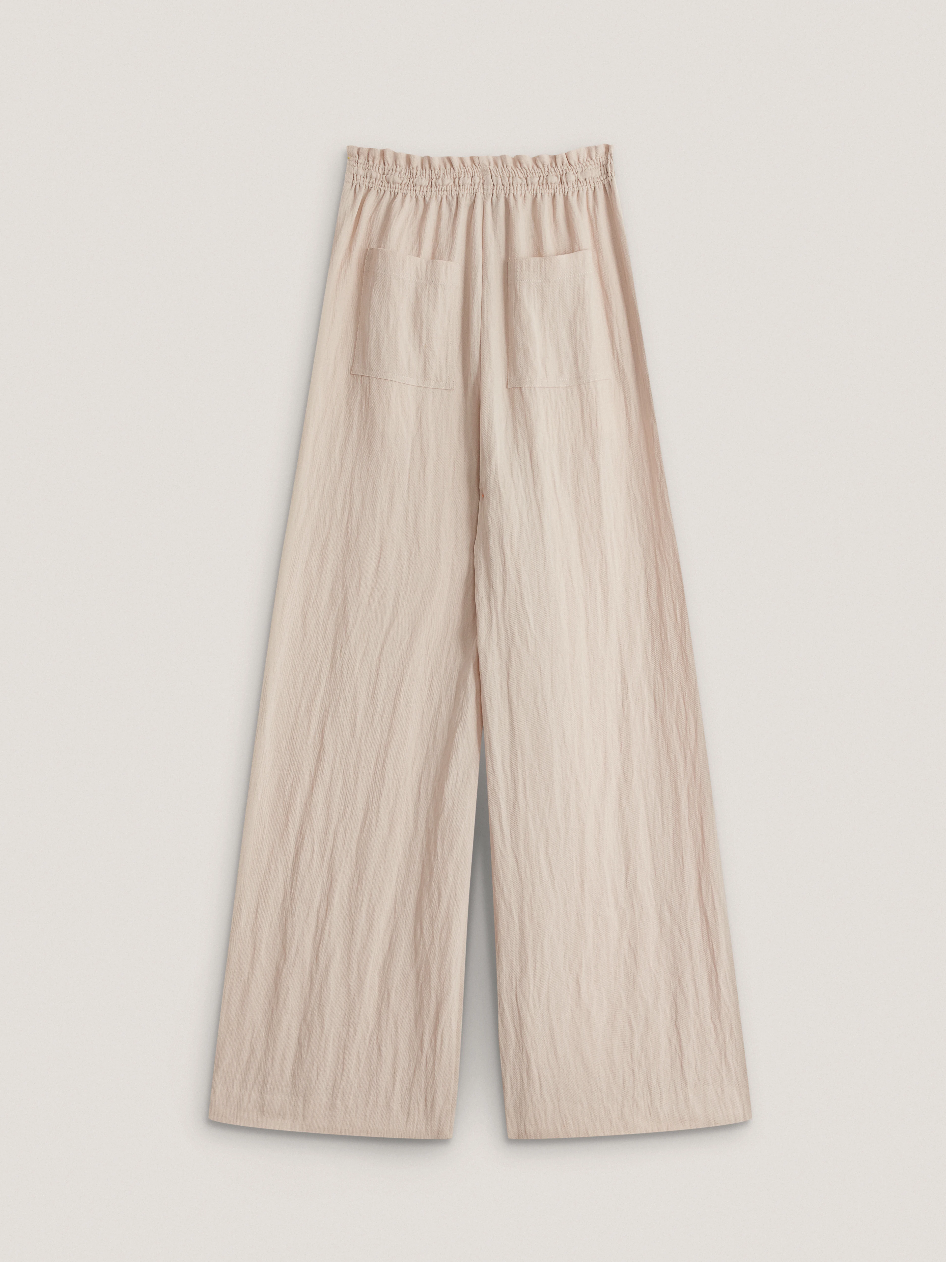Loose-fitting beige trousers