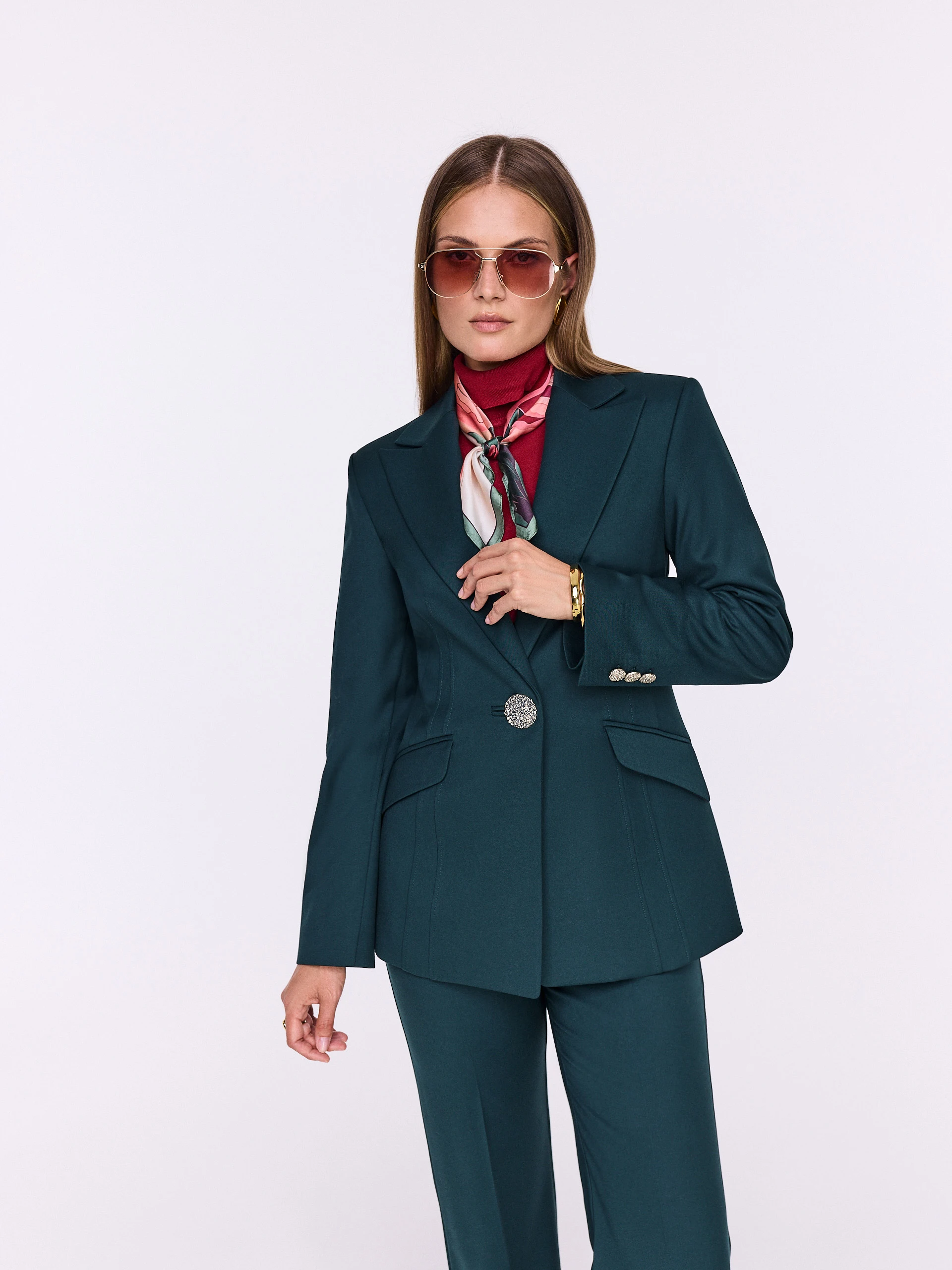 Dark green fitted jacket with decorative button
