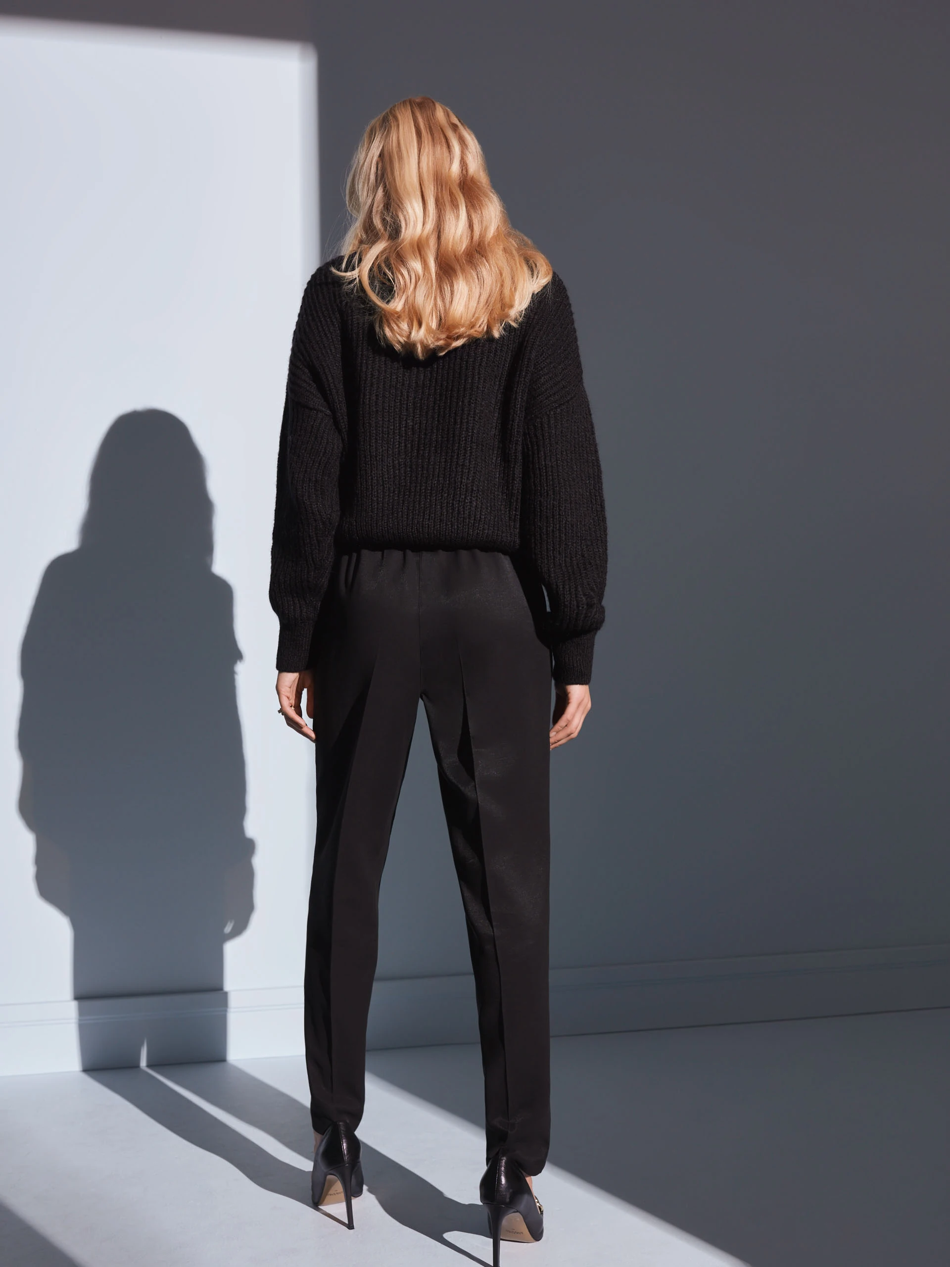 BLACK SWEATER WITH TASSELS