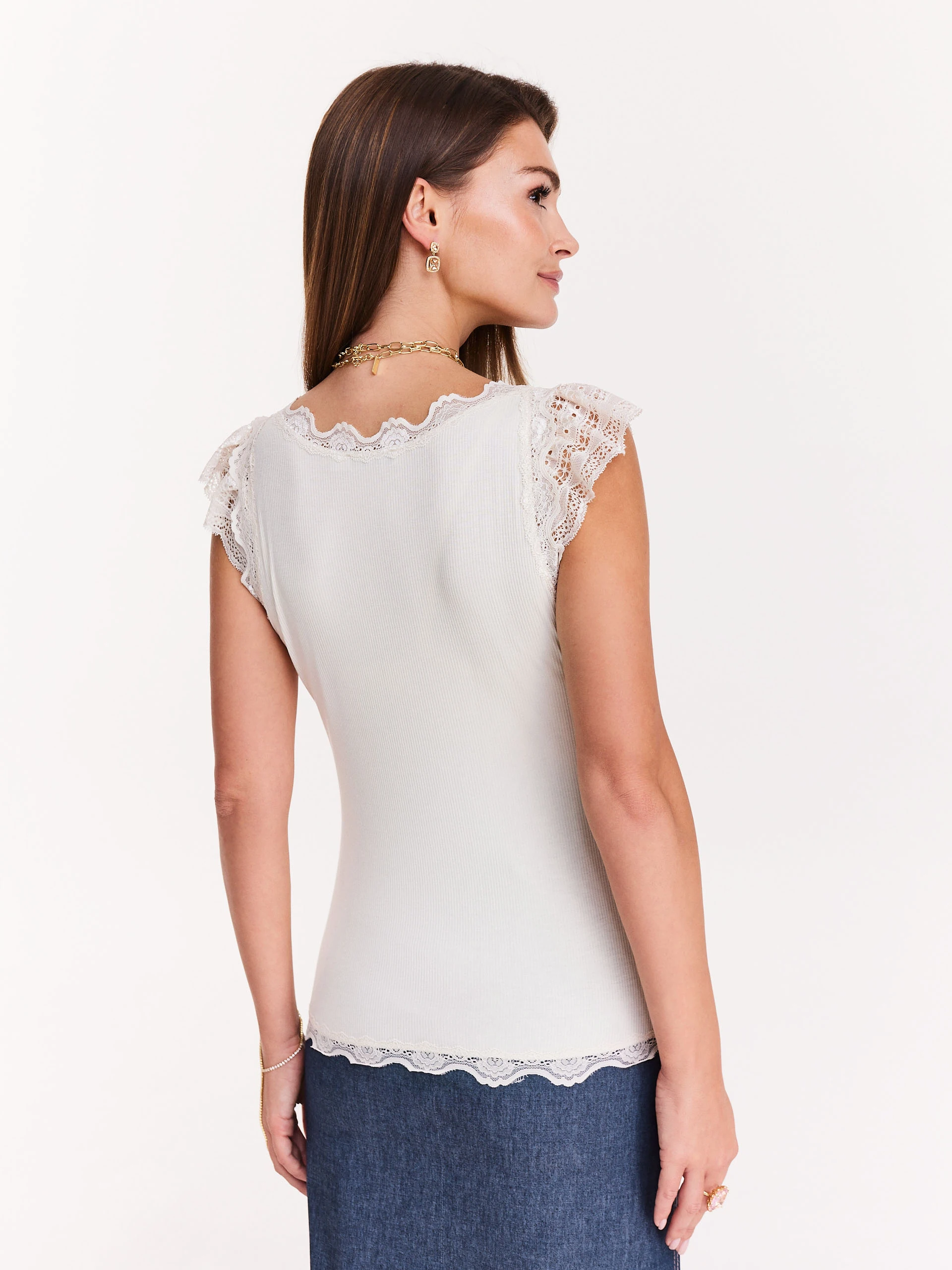Ribbed white blouse with lace inserts