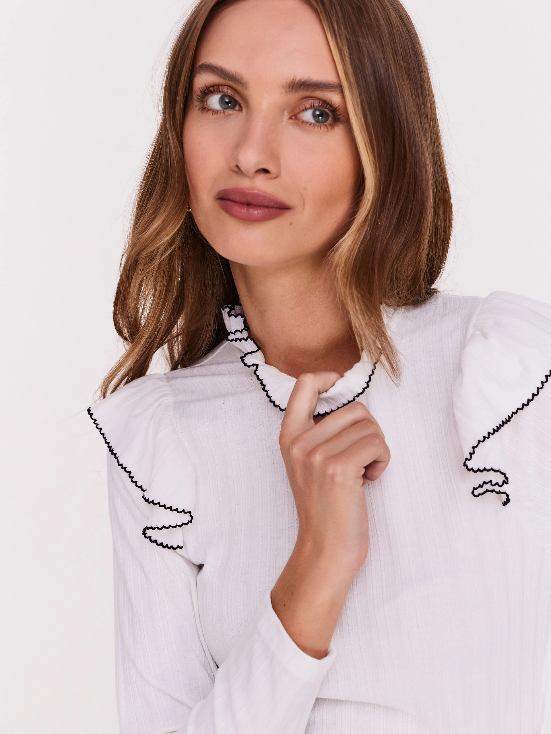 White blouse with stand-up collar and ruffles