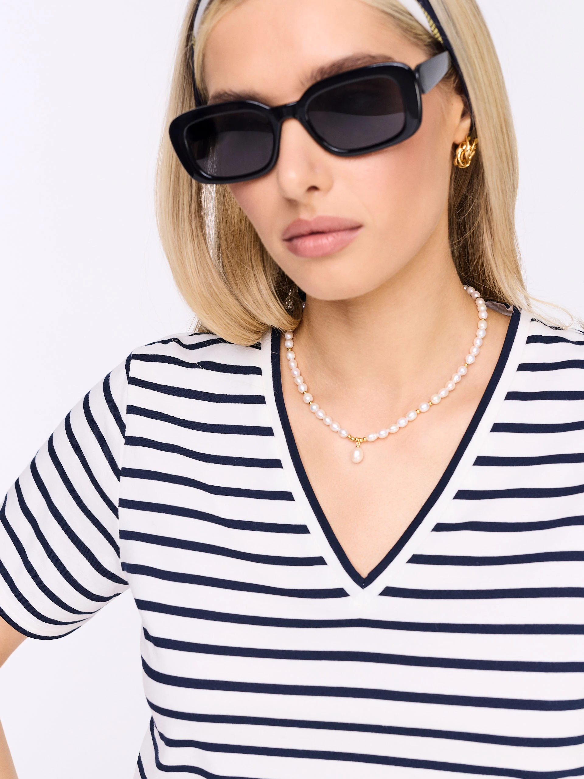 White blouse with navy blue stripes and a V-neck