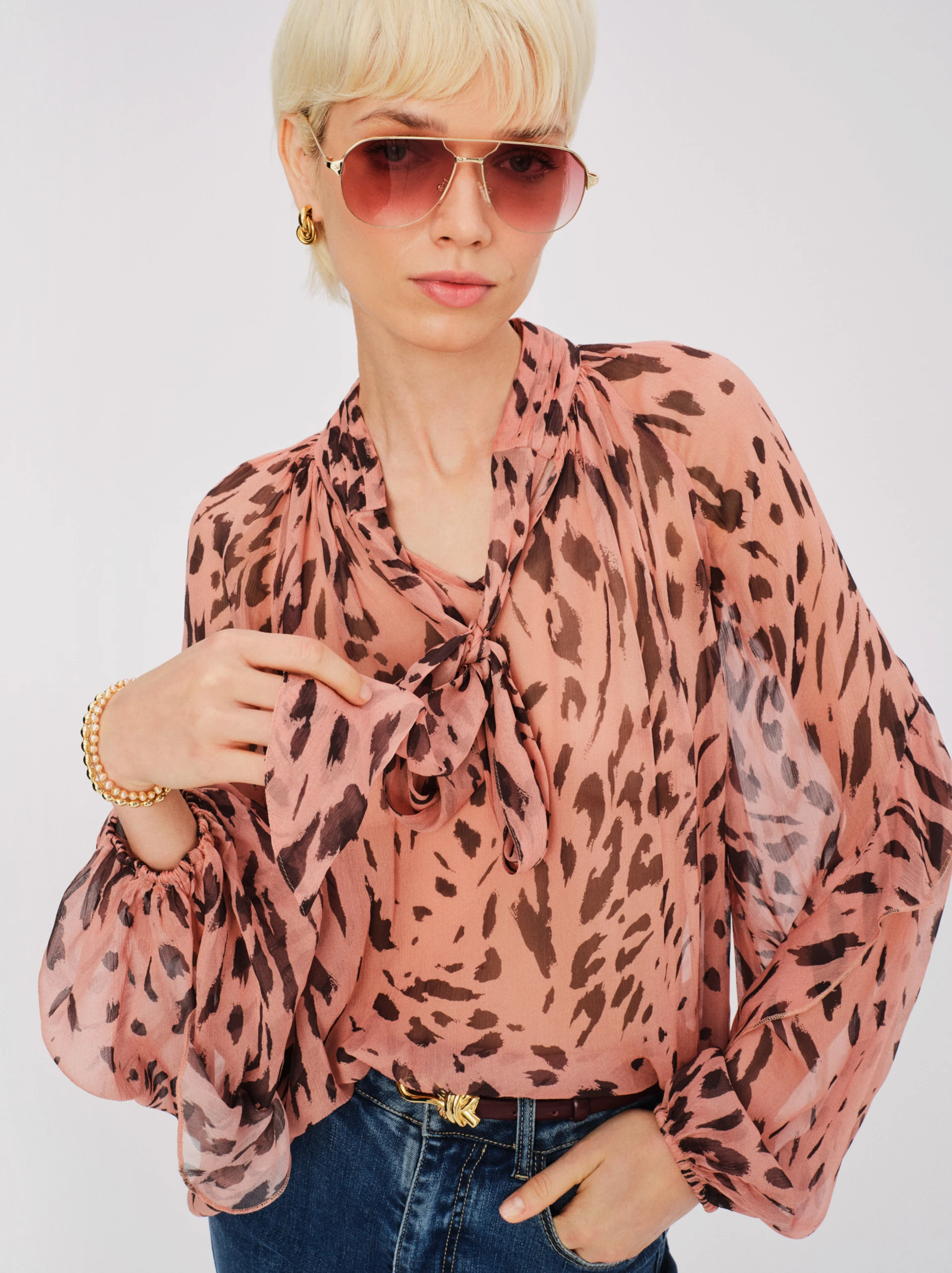 Airy pink spotted blouse with a tie at the neck