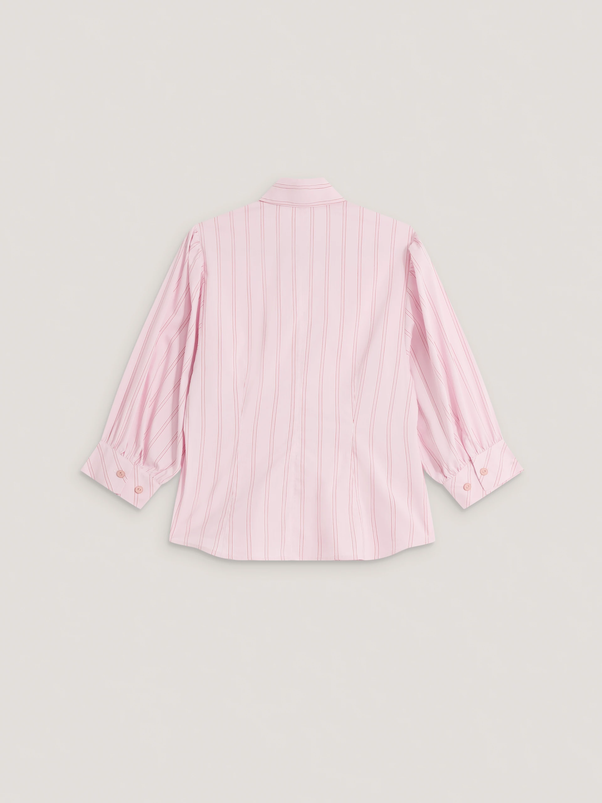 A light pink, fitted, ribbed blouse