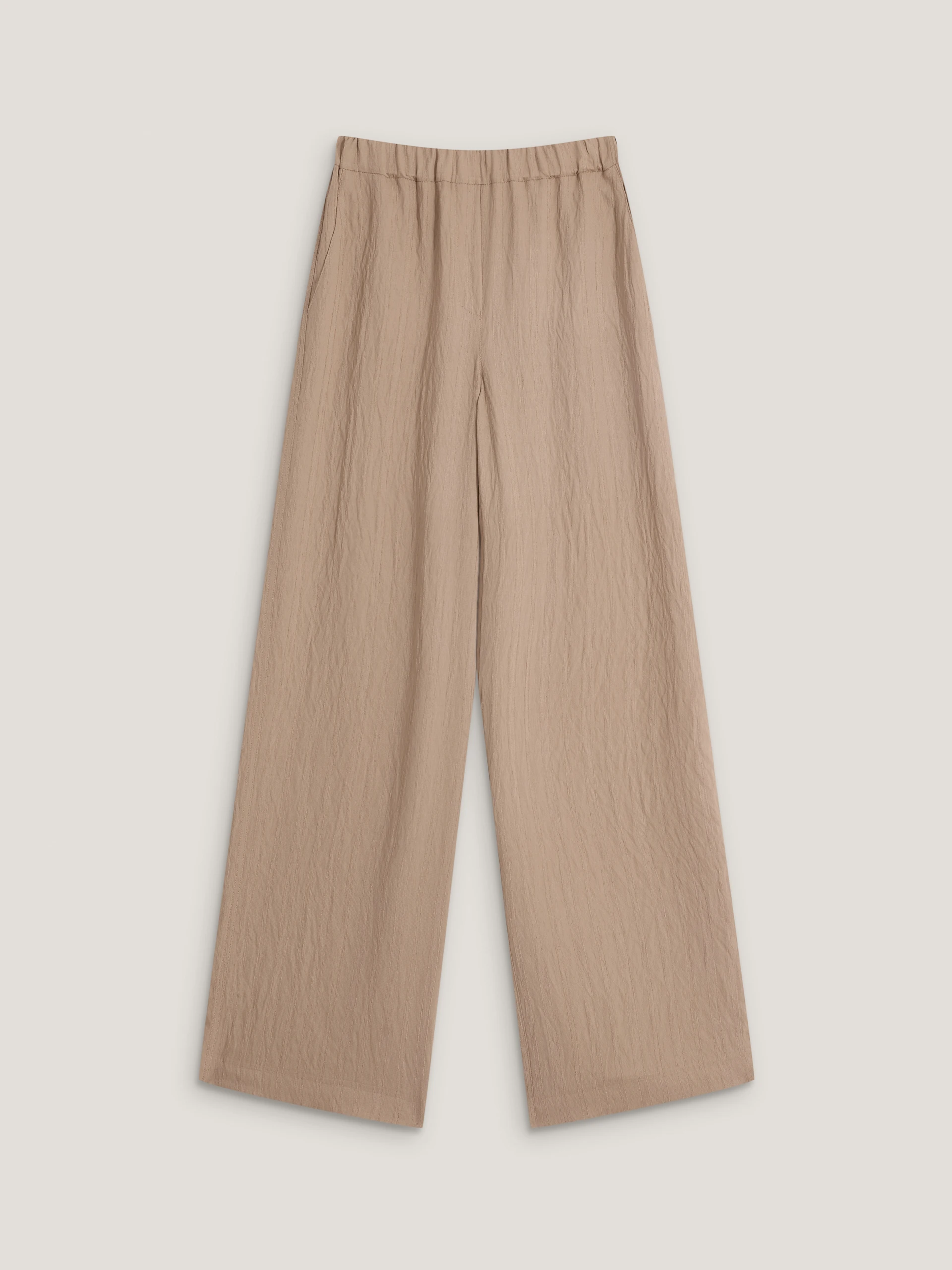 Beige high-waisted trousers with a subtle ribbed pattern