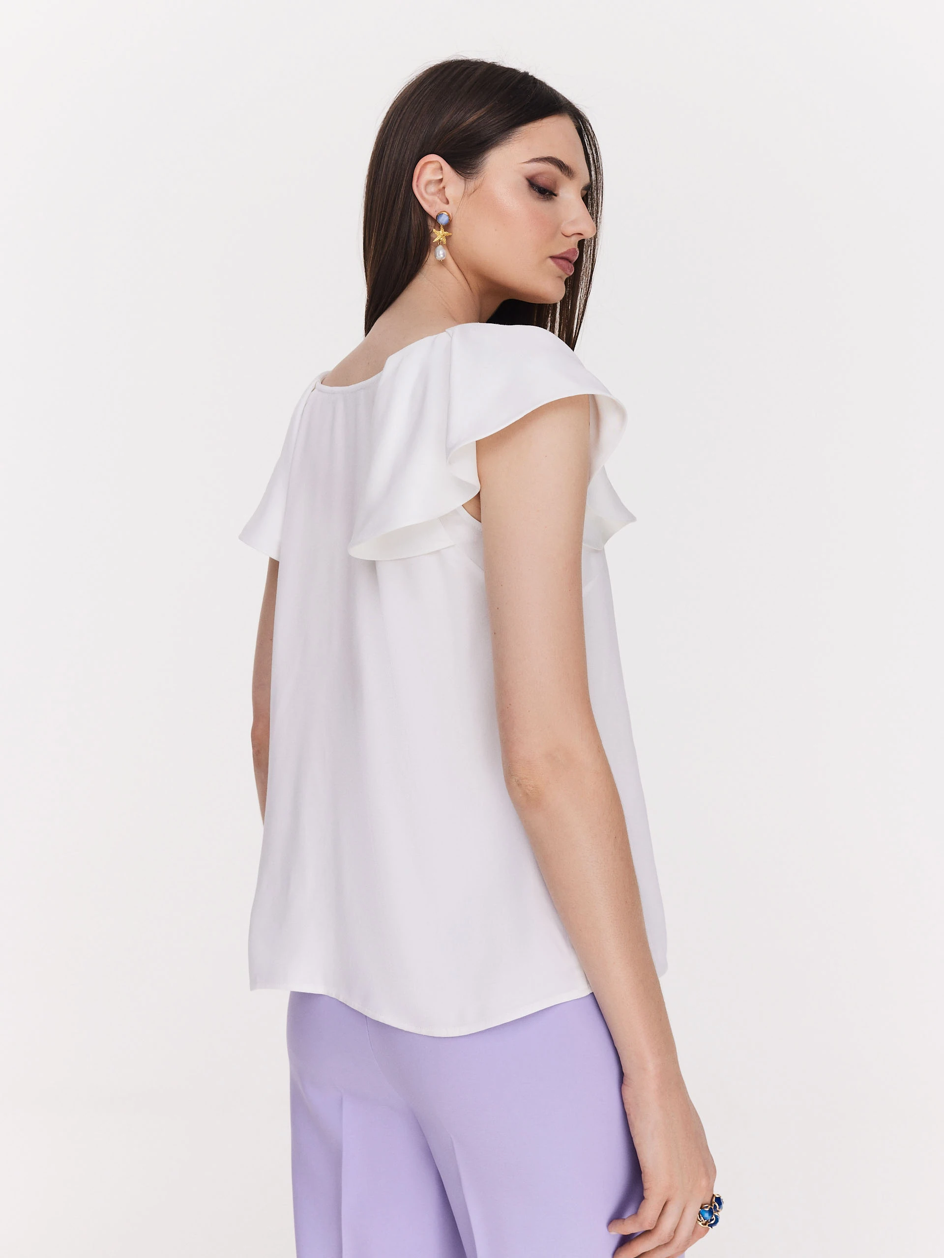 Loose white blouse with ruffle