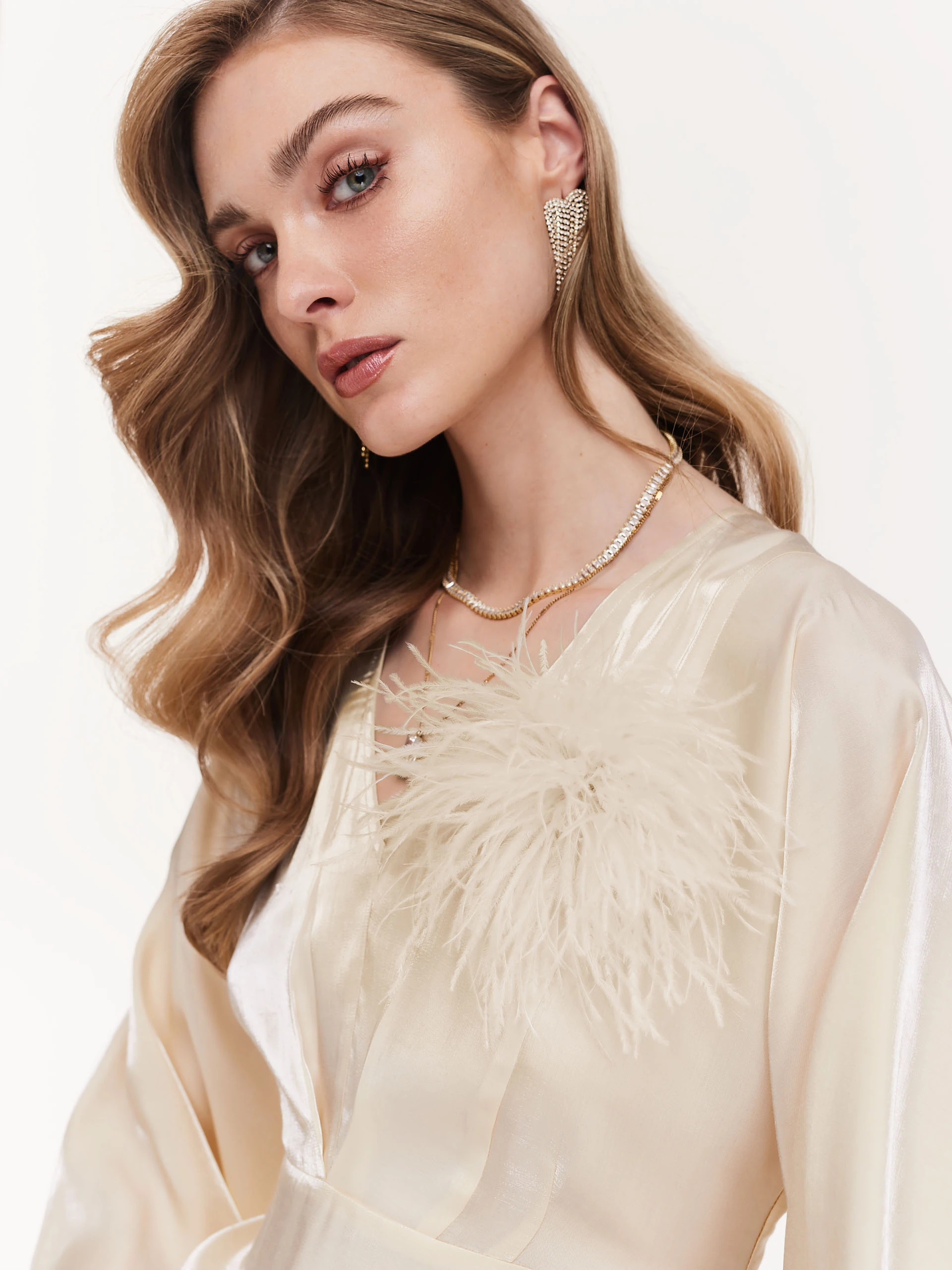 Cream brooch with feathers