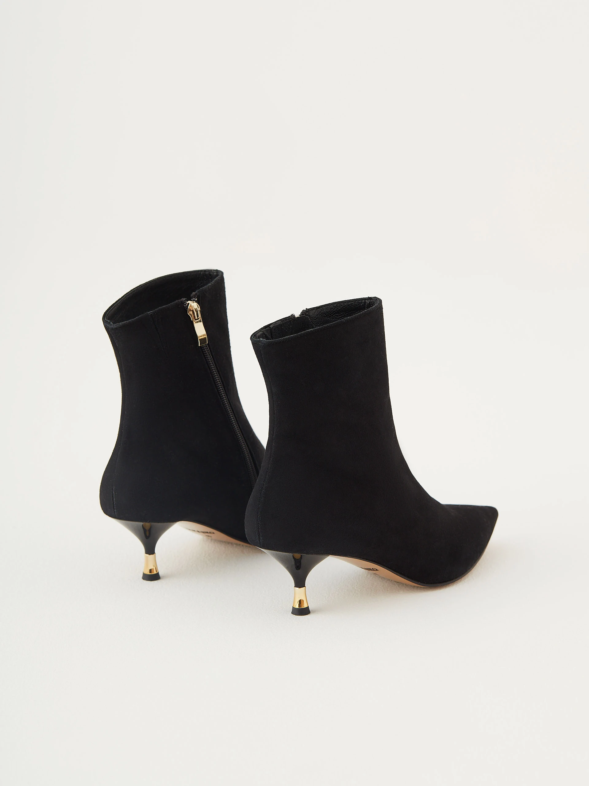 Black suede boots with gold elements