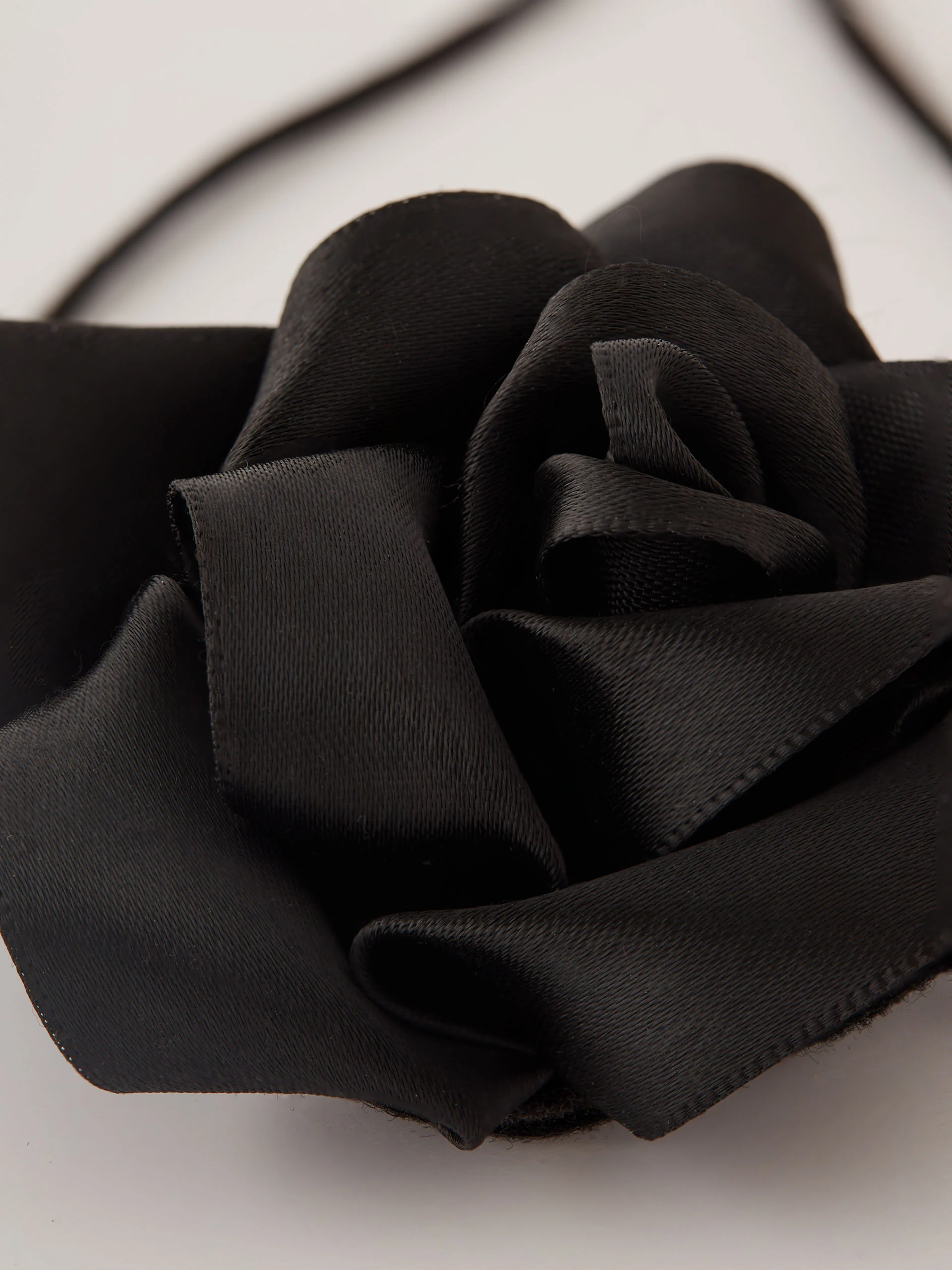 Black rose necklace on a thong