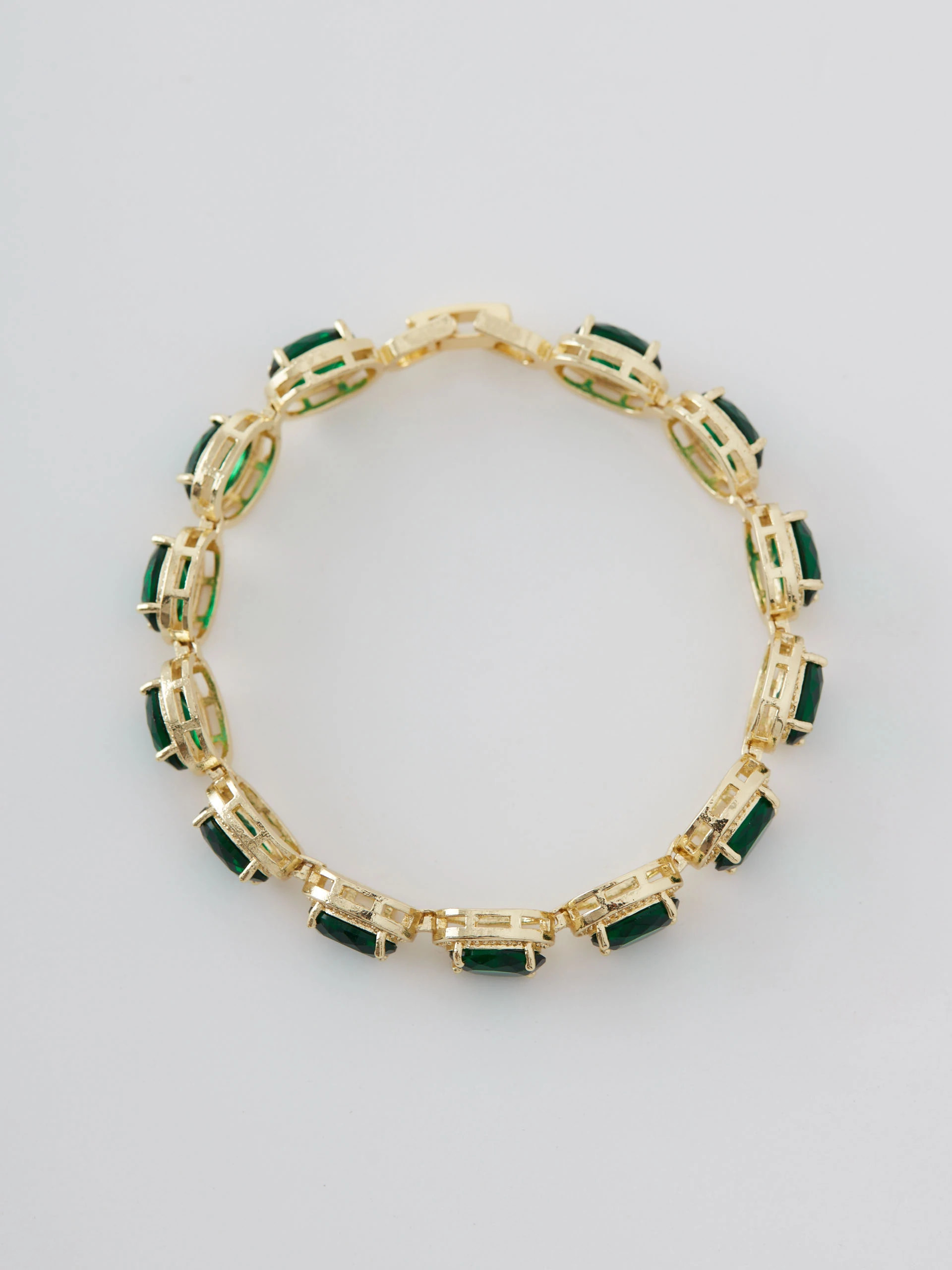 Gold-tone copper bracelet with green zircons