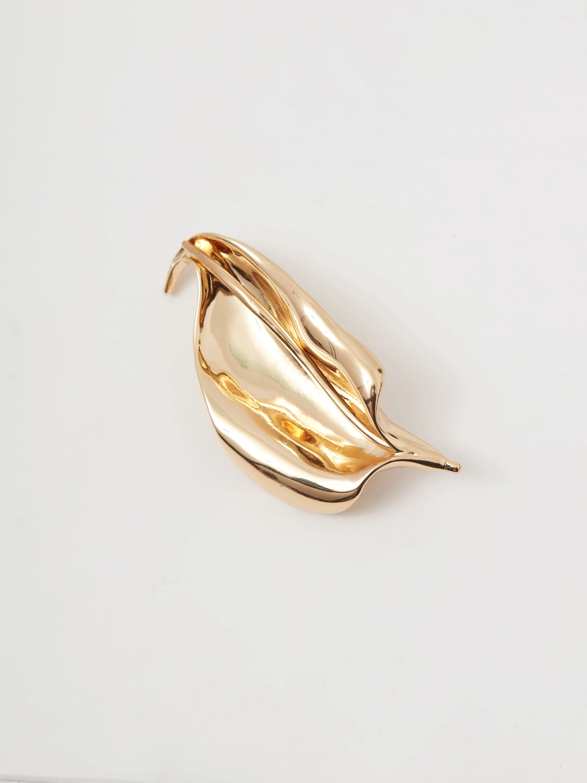 Gold-colored leaf-shaped brooch