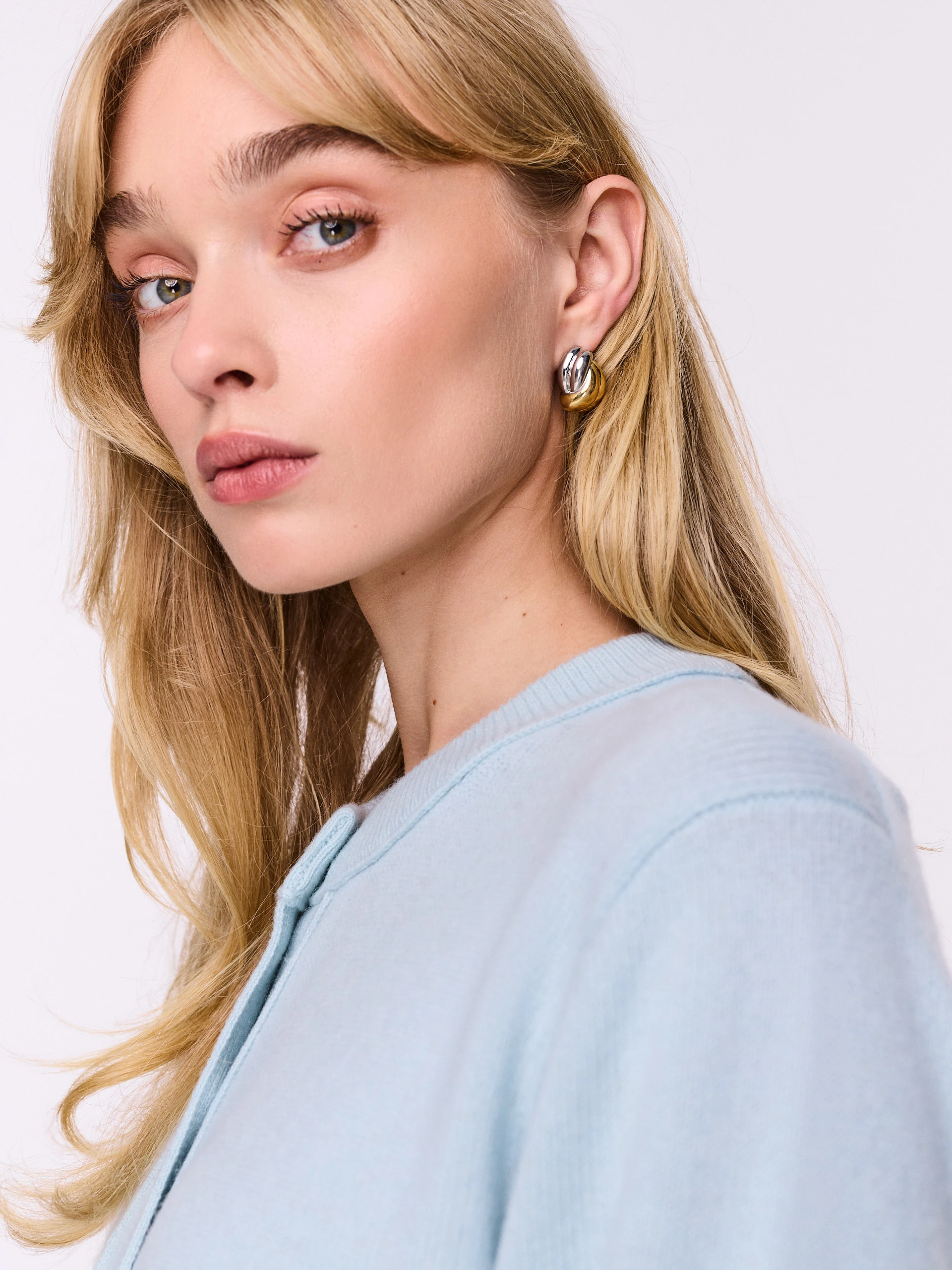 Gold and silver knot-shaped earrings