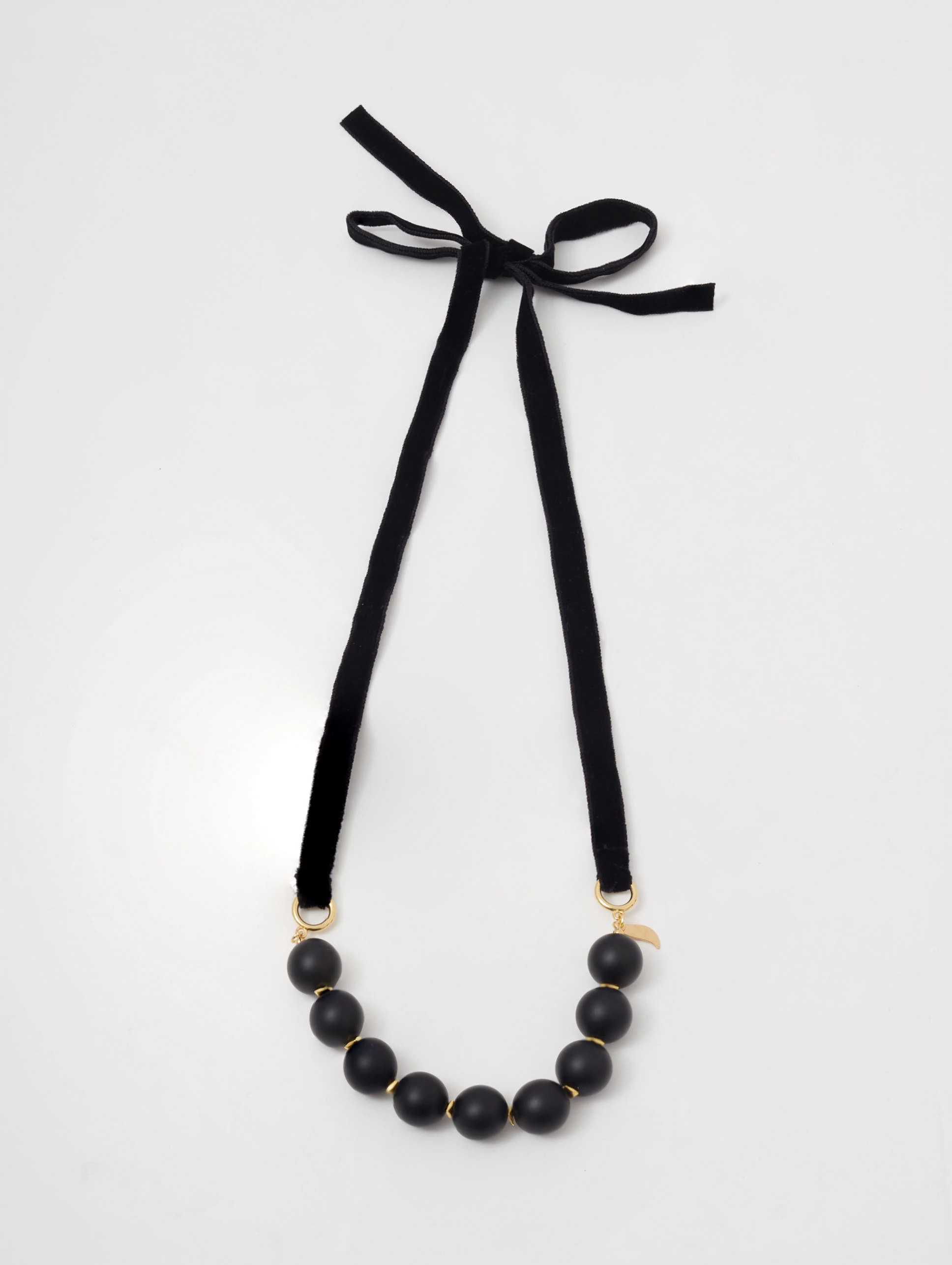 Gold-plated necklace with onyx and hematite stones on a ribbon