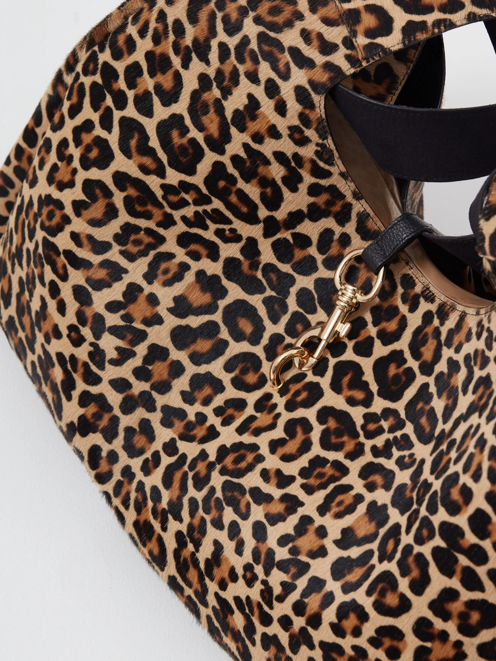 Leather handbag with a leopard print and fur texture