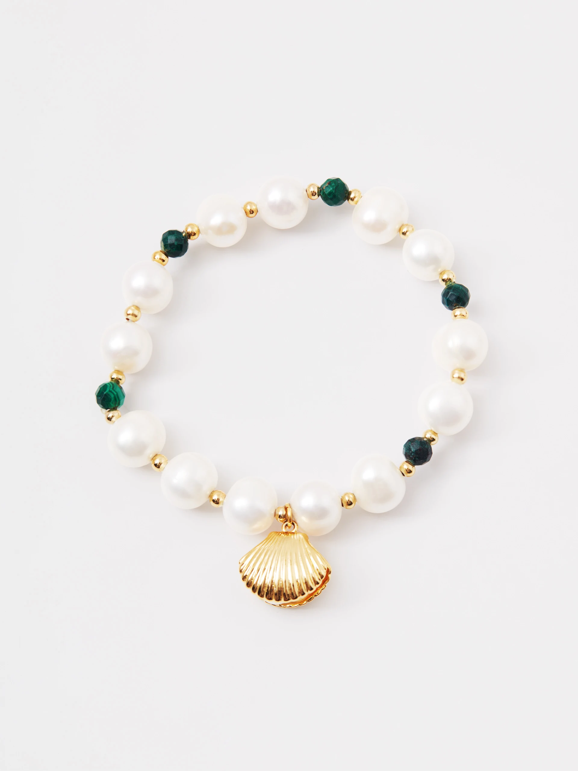 A pearl bracelet with a seashell-shaped charm