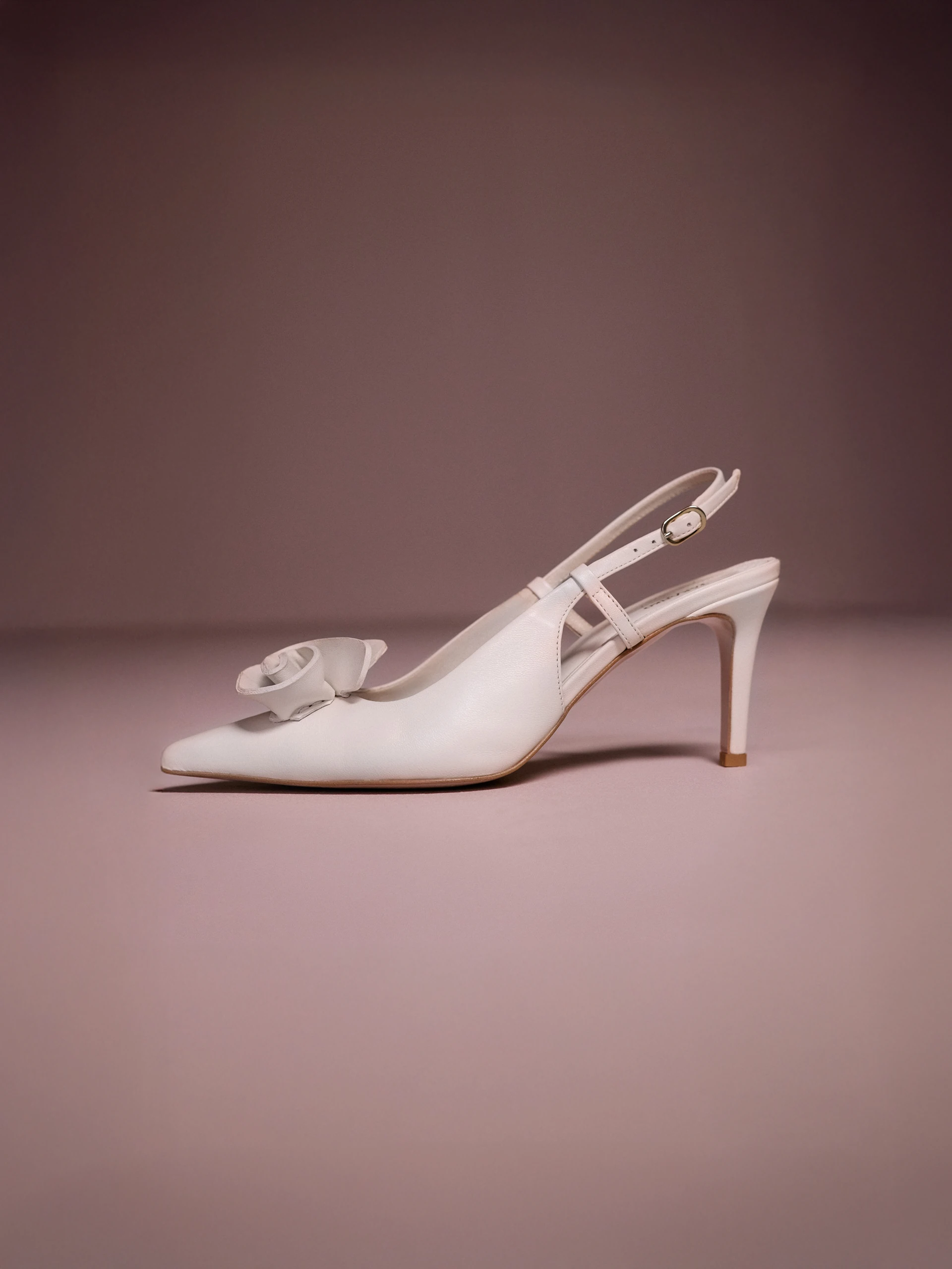 Cream-colored leather pumps with a flower