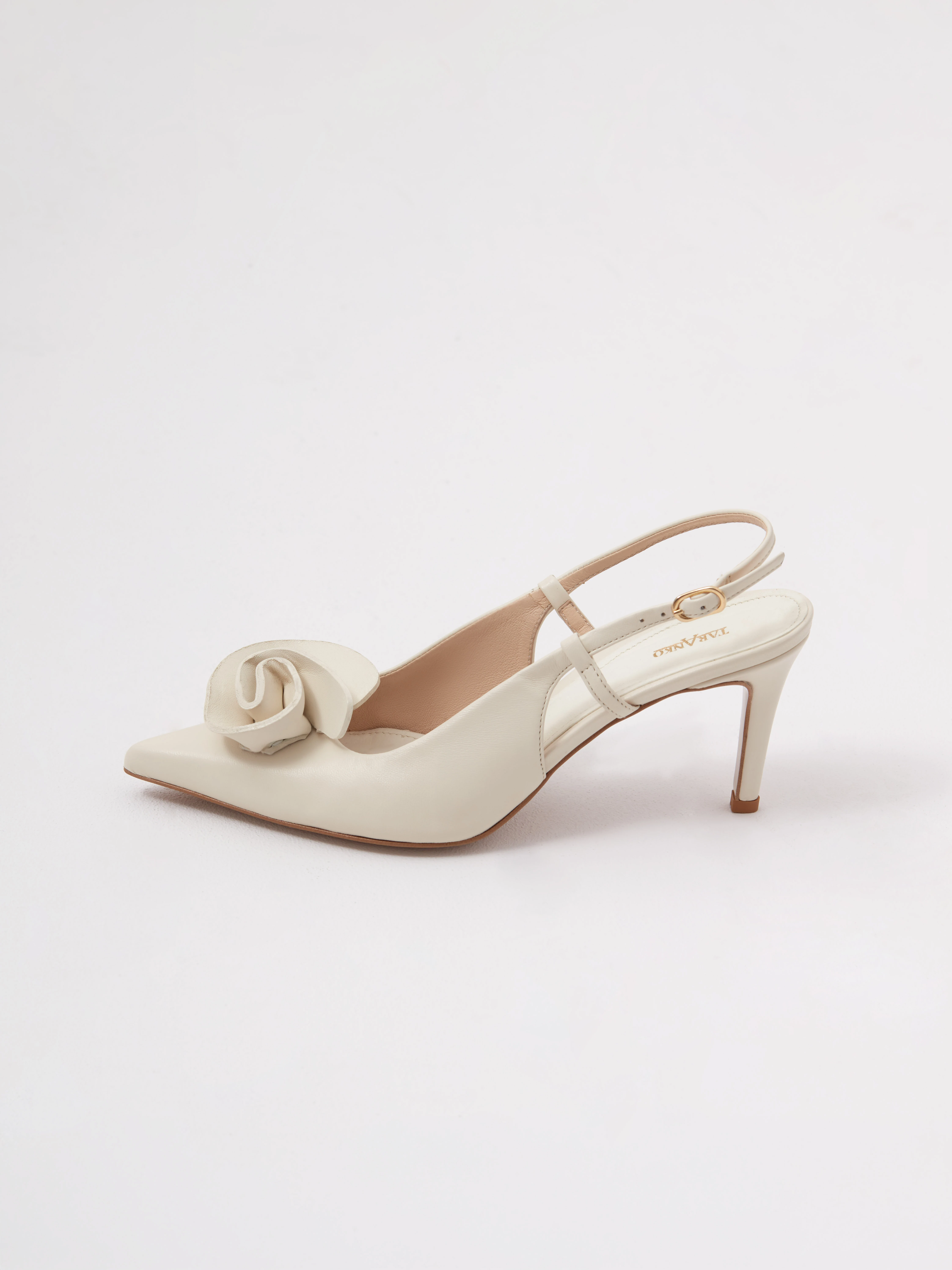 Cream-colored leather pumps with a flower