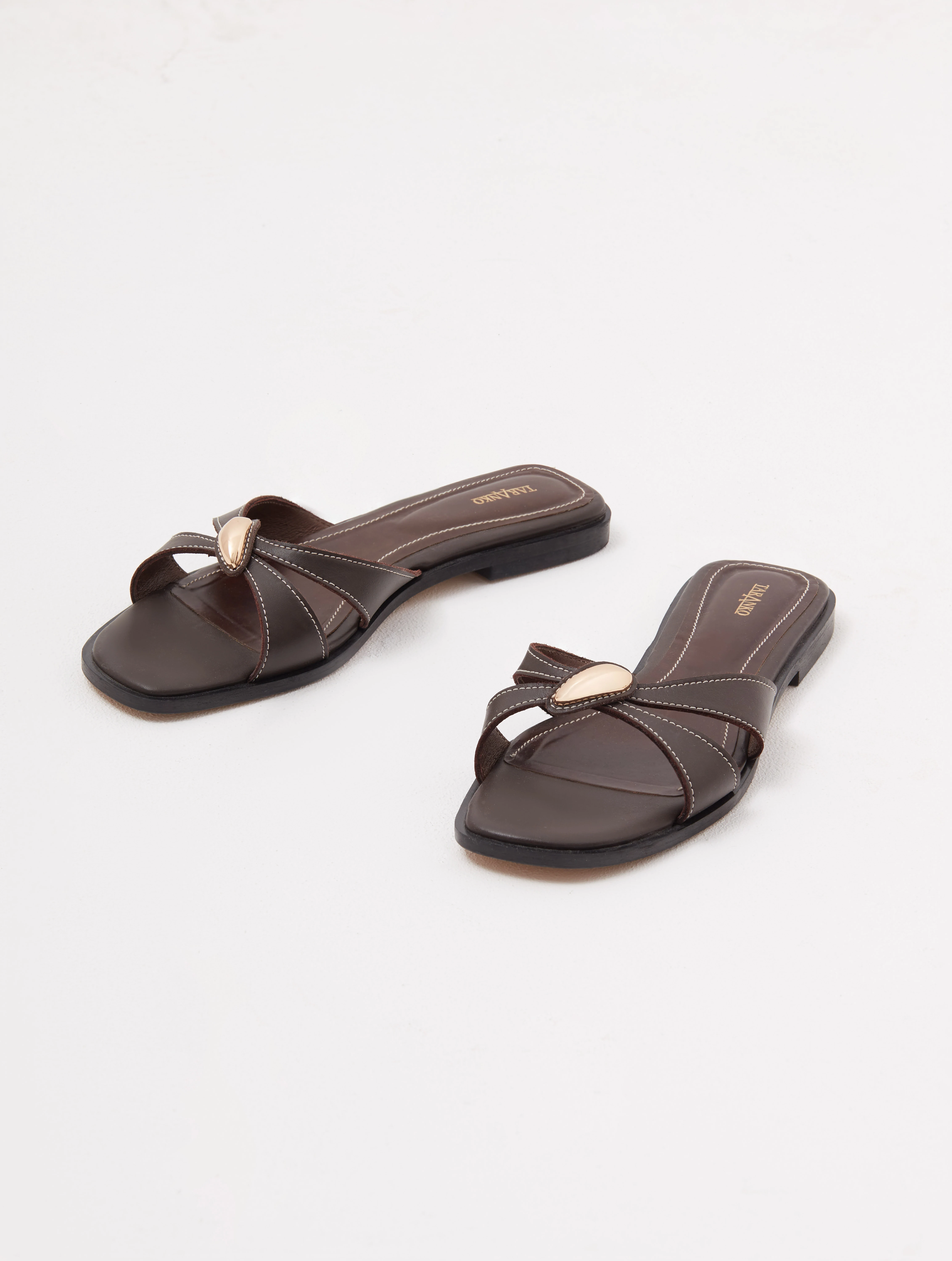 Brown leather flip-flops with decorative buckles