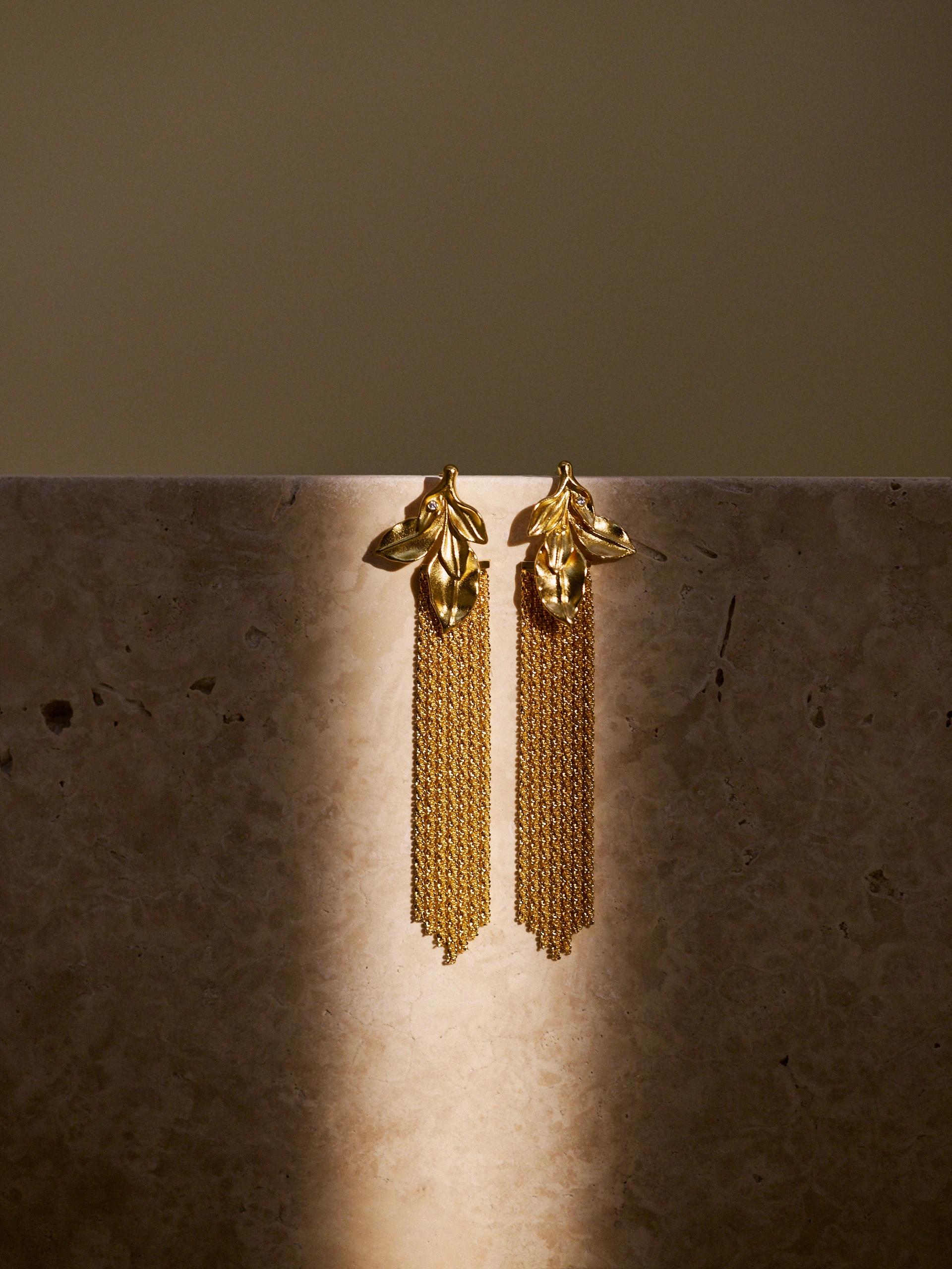 Long gold-colored earrings